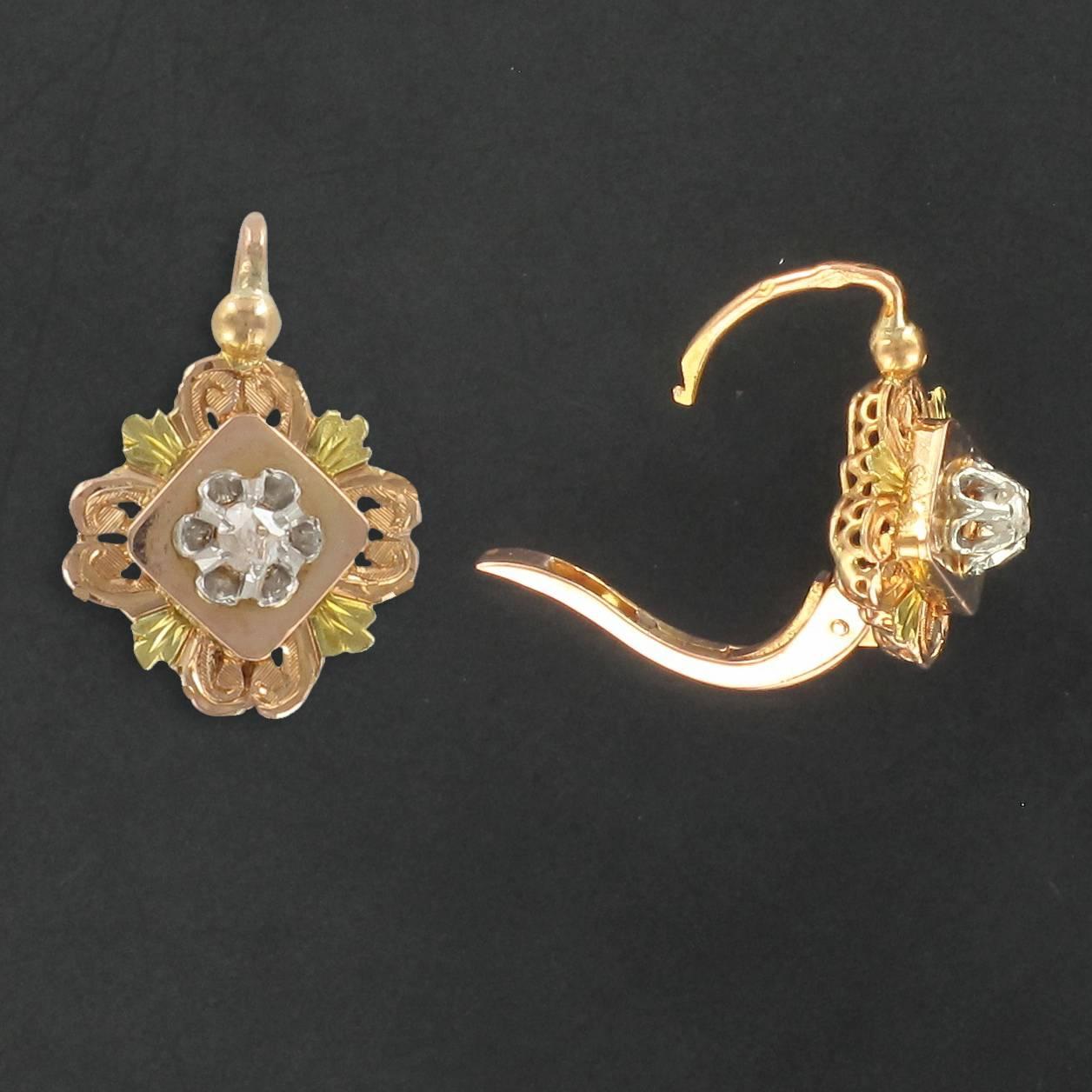 Earrings in 18 carat rose gold, eagle head hallmark. 

Each of these antique earrings features a diamond shaped plaque decoratively edged with a delicately engraved rose gold and green gold design. At the centre of each plaque is a claw set