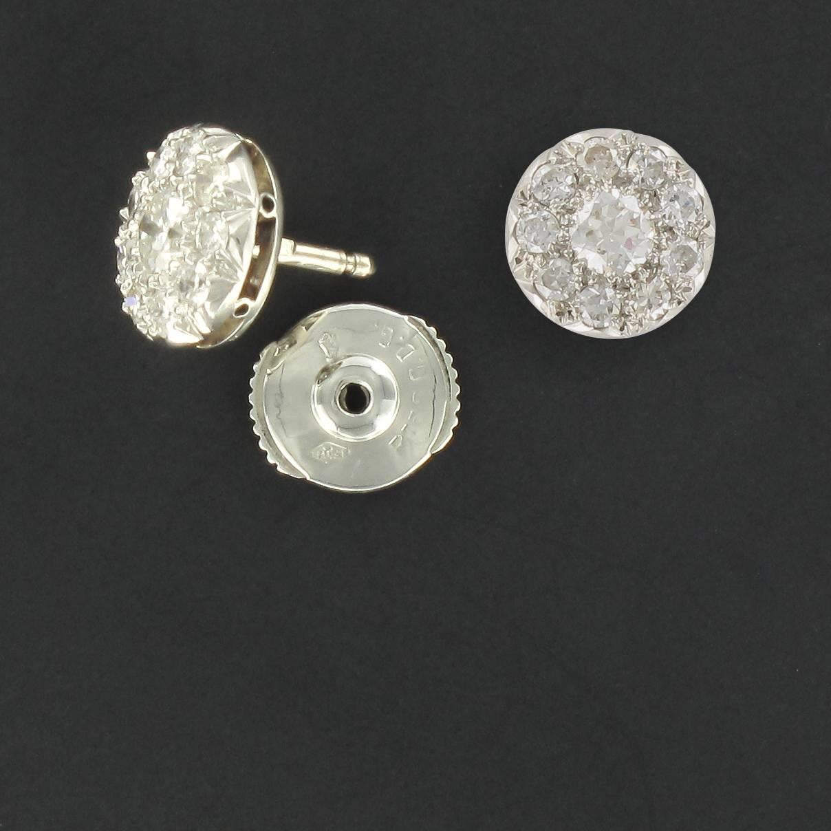 Earrings in 18 carat white gold, eagle head hallmark.

Each round white gold stud earring is set with 10 modern brilliant cut diamonds. The central diamond of each is the largest. They feature Alpa clasps at the back. 

Total diamond weight: about