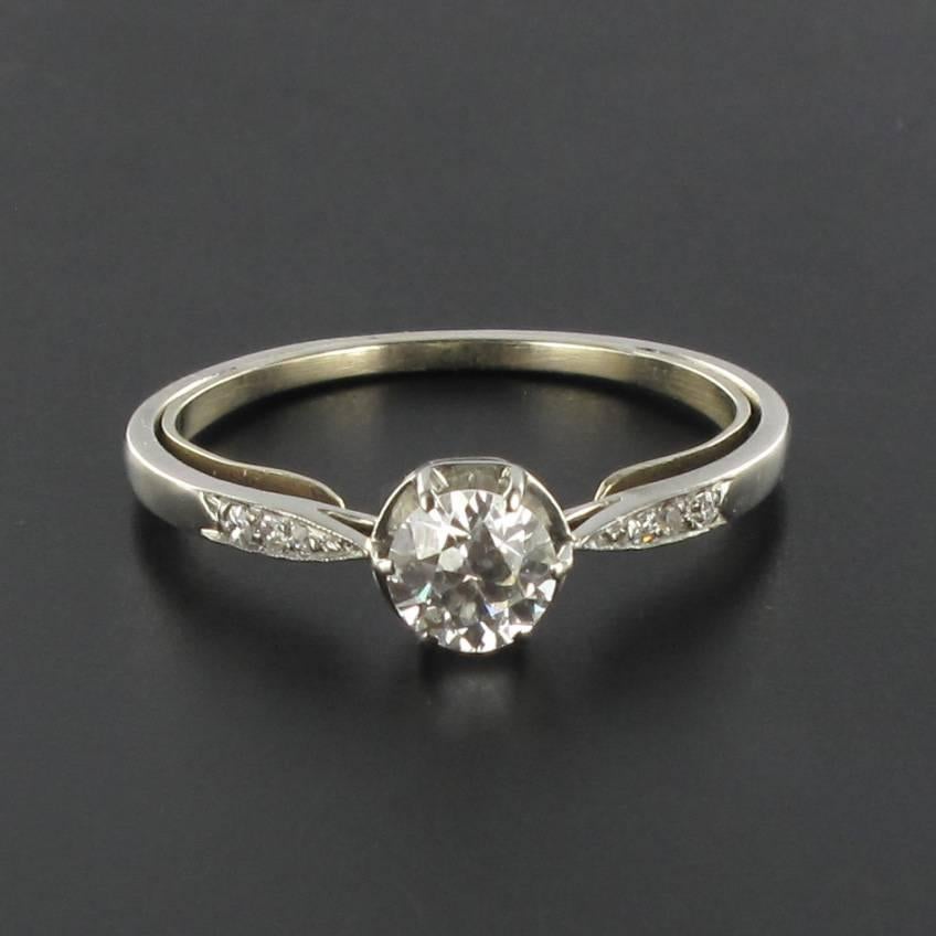 Platinium ring, dog's head hallmark. 

A very feminine solitaire ring featuring a brilliant cut solitaire diamond held by 6 claws with 3 rose cut diamond on each side. 

Weight of the center diamond: 0.46 carat approx - Estimated Quality: H.VS.