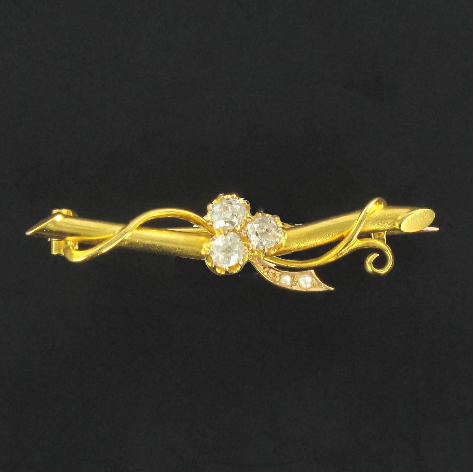 18 carat Yellow gold brooch, eagle head hallmark.
This lovely gold brooch is composed of a gold branch entwined with a gold cord on which is a 3 leaf clover set with 3 extremely high quality antique cut diamonds and 2 half pearls set in the stalk.