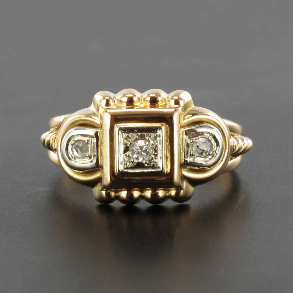 Ring in 18 carat yellow gold, eagle head hallmark.

This tank ring with its typical geometric lines boasts a gorgeous diamond within a square shaped design. 
On each side are round motifs set with rose cut diamonds. The beginning of the ring band at