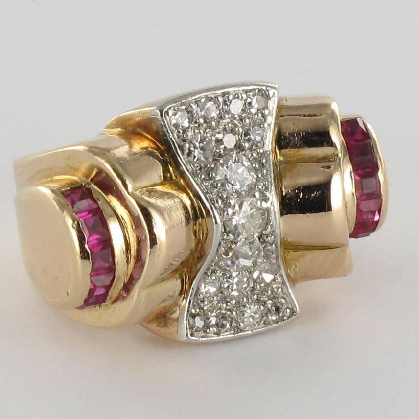 Platinium and 18K yellow gold ring.

This sublime retro ring is set on a bed of rose cut diamonds on a platinum bed with, on each shoulder, a line of calibrated synthetic rubies. 

Total diamond weight: about 0.50 carat.
Height 1.8 cm, width