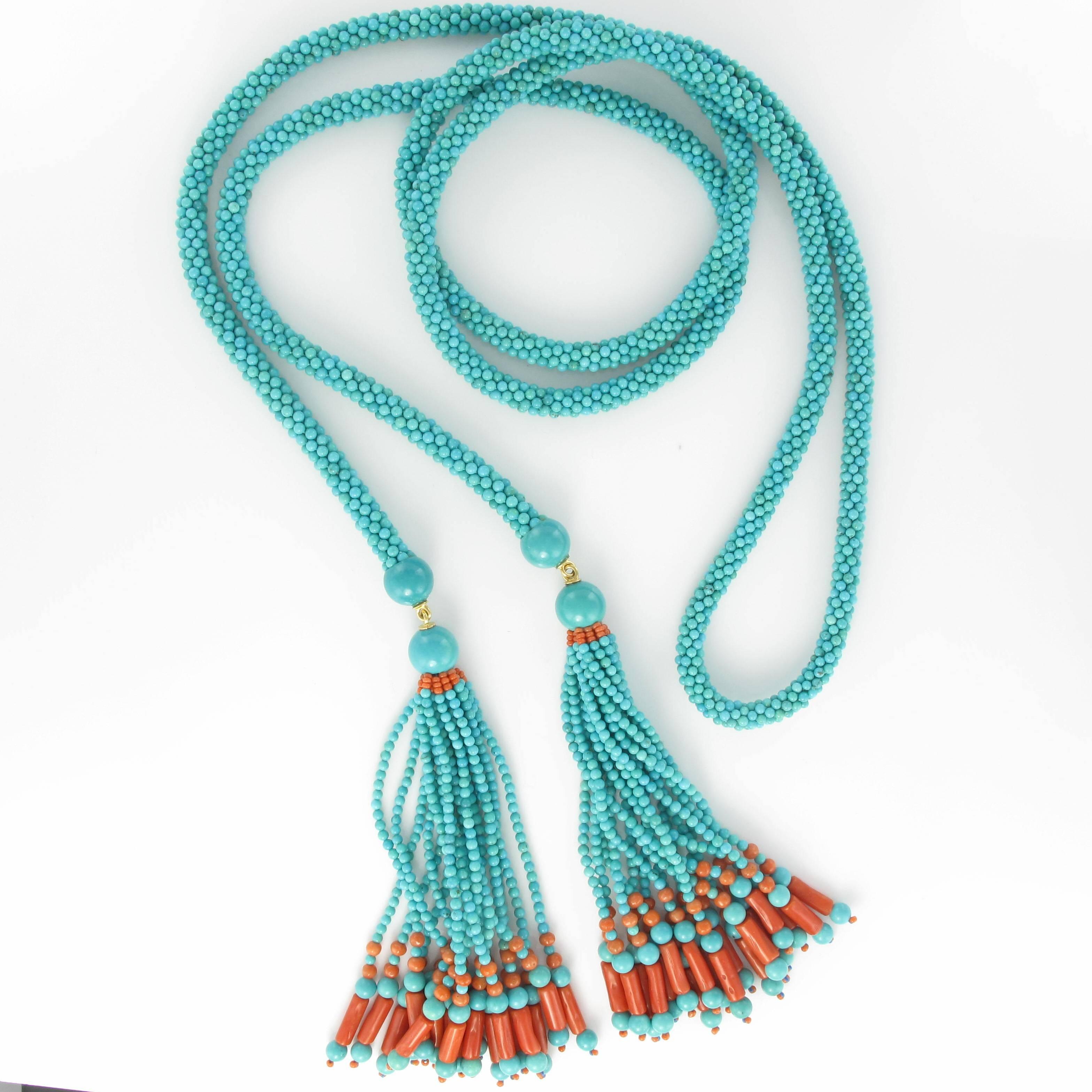 Baume creation - unique piece

A rope style ‘Tie’ necklace made of many small turquoise beads. At each end, two large turquoise beads hold two gold rings each with tassels leading to 18 strands of turquoise beads decorated with coral beads and