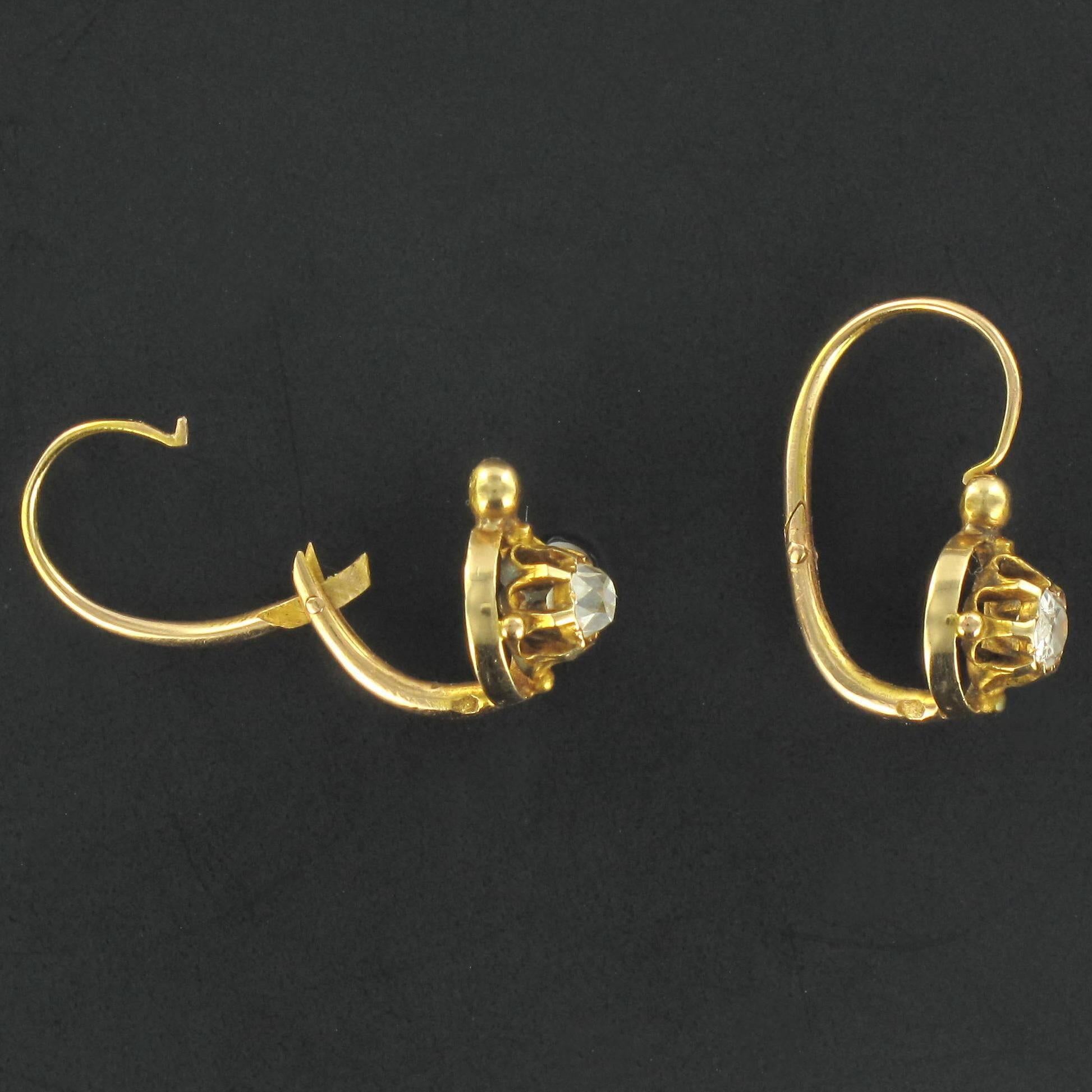 Earrings in 18K yellow gold, eagle head hallmark.

Each charming antique earring has a claw set cushion cut antique diamond accentuated at the four cardinal points with a small golden bead, with a larger gold bead above. The clasps are at the