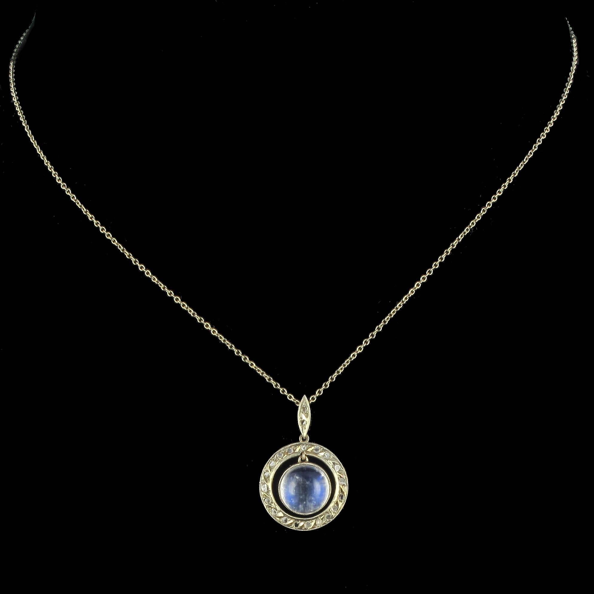 sRing in 18 carat white gold, eagle head hallmark. 

This antique pendant is in the form of a circle set with rose cut diamonds. At the centre of this Art Deco pendant hangs an iridescent moonstone cabochon. The shuttle shaped pendant fitting is