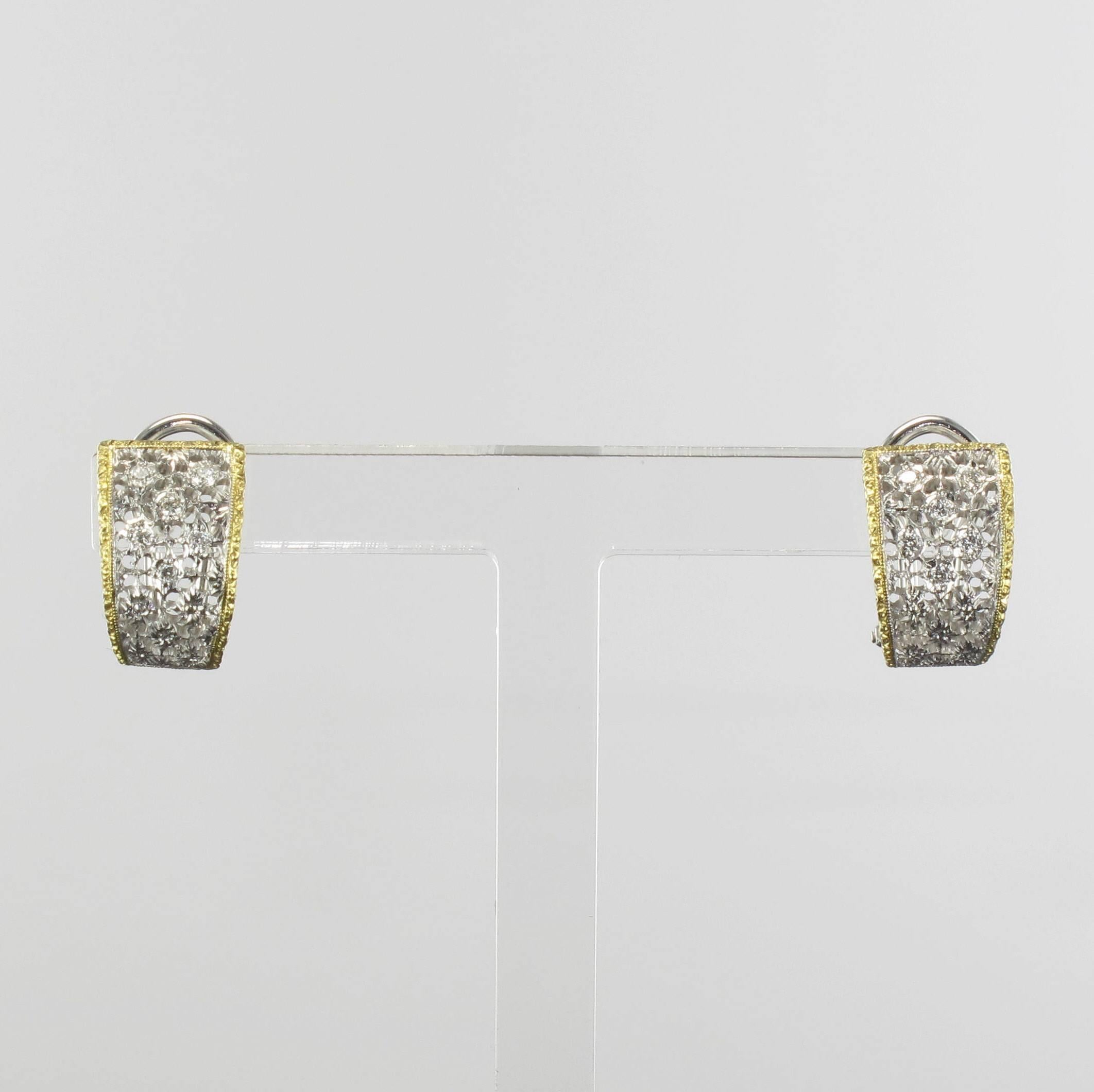 Earrings in 18 carat, white and yellow gold.

These delightful white gold curved earrings are half Creole in style. Each Creole earring is of openwork white gold, set with 8 small brilliant cut diamonds at the front and edged with yellow gold