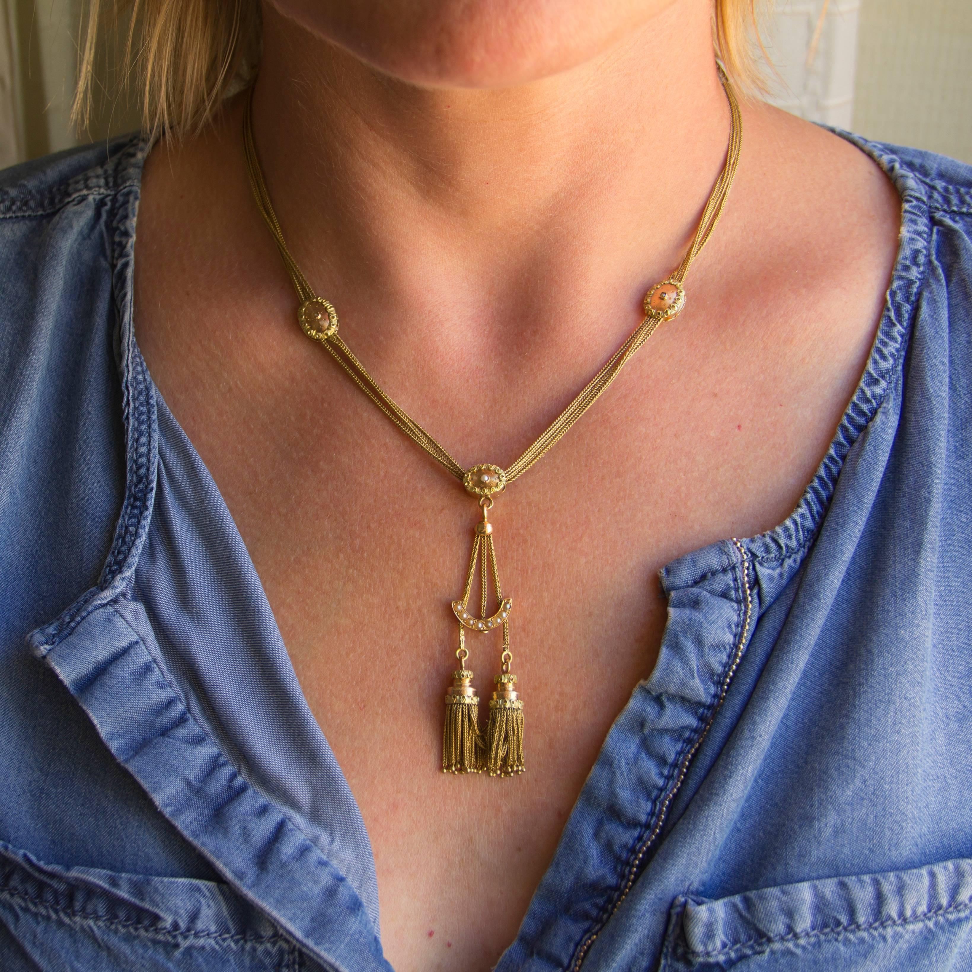 Necklace in 18 carat yellow and pink gold, horse head hallmark. 

Composed of chain strands suspended from a double sided guilloche pattern set with a fine pearl. The same design is represented in the pendant as a slide holding a crescent set with