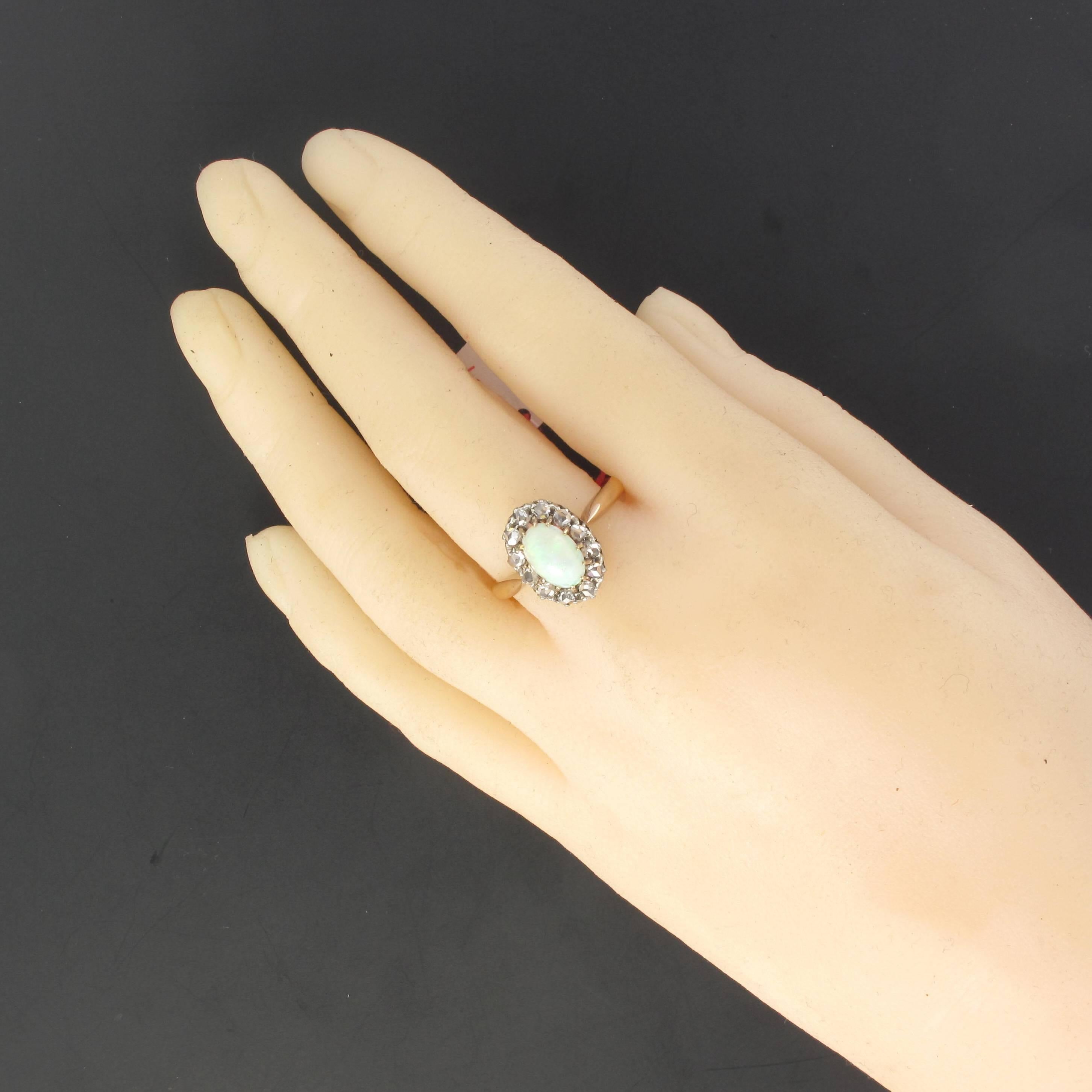 Ring in 18 karat rose gold. 
This ring features a 12 claw set opal cabochon with a halo of rose cut diamonds. 
Height: 1.4 cm, width 1.1 cm, thickness: 8 mm.
Opal weight: about 1.05 carats.
Total weight of the jewel: 5 g approximately.
US Size :