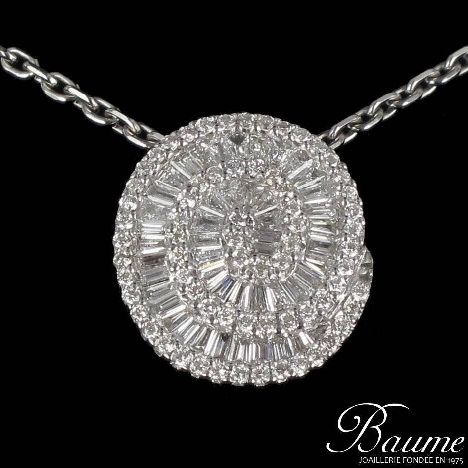 Oval pendant in 18 karat white gold. 
In the form of a spiral entirely set with brilliant cut and trapeze cut diamonds in invisible settings. 
This pendant is sold alone without the display chain. 
Total diamond weight: about 0.80 carat - Estimated
