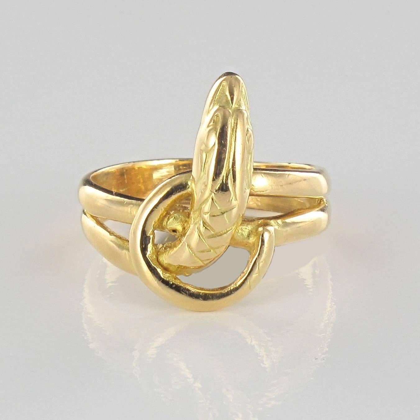 Ring in 18 carat yellow gold, owl hallmark. 

This splendid gold ring is typical of the style worn by both men and women in the 19th Century. A wide ring that features a snake with its body coiled around the finger twice. 

Width: 2.1 cm,