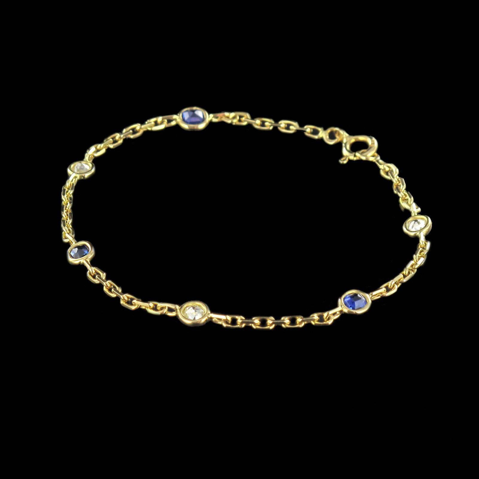 Baume creation.

Ring in 18 carat yellow gold, eagle head hallmark. 

The chain links are regularly and alternately interspersed by 3 diamonds and 3 blue sapphires in bezel settings. This bracelet has a spring ring clasp. 

Length: 18.5 cm,