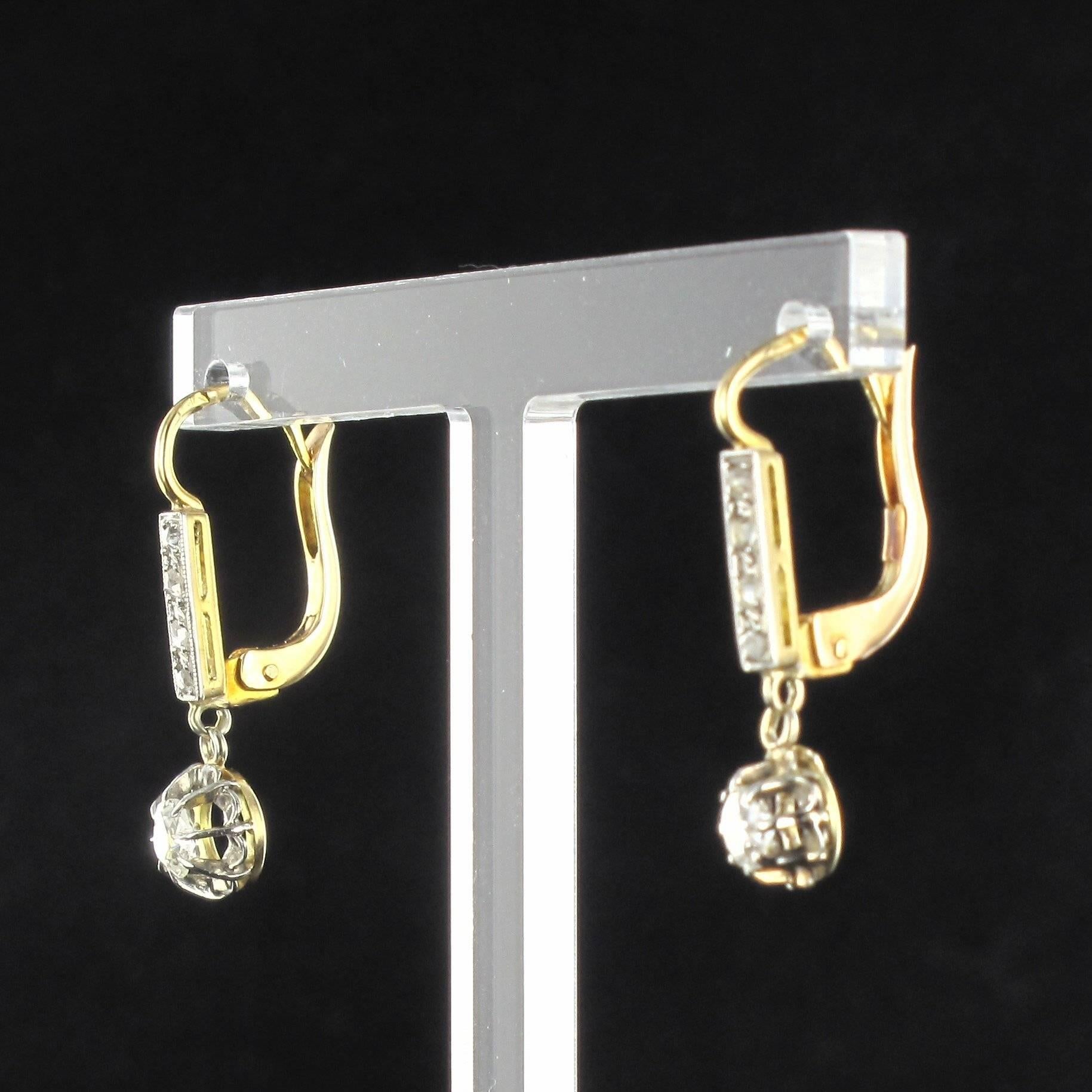 For pierced ears. 

Pair of earrings in platinium and 18 carat yellow gold, dog and eagle heads hallmarks. 

Each earring is composed of a column of 4 rose cut diamonds that holds a suspended antique brilliant cut diamond. These earrings open at