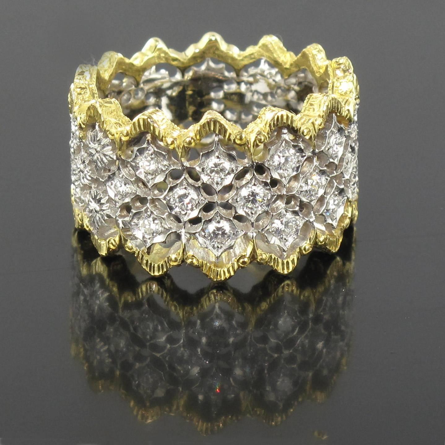 
Ring in 18 carat yellow and white gold. 

This wide diamond ring features white gold filigree set with 13 small brilliant cut diamonds edged with yellow gold filigree. 

Total diamond weight: about 0.34 carat.
Width: 1.3 cm
Total weight: