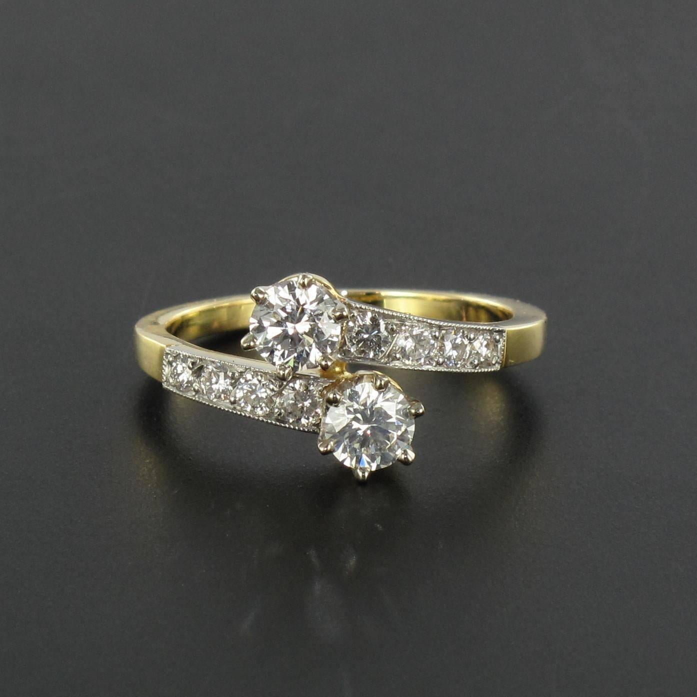 Ring in platinium and 18 carat yellow gold, eagle head hallmark.   

This Lovers ring is claw set with 2 brilliant cut diamonds. The beginning of the ring band on each side is set with 4 diamonds.   

Total 2 center diamond weight: 0,77 carat.