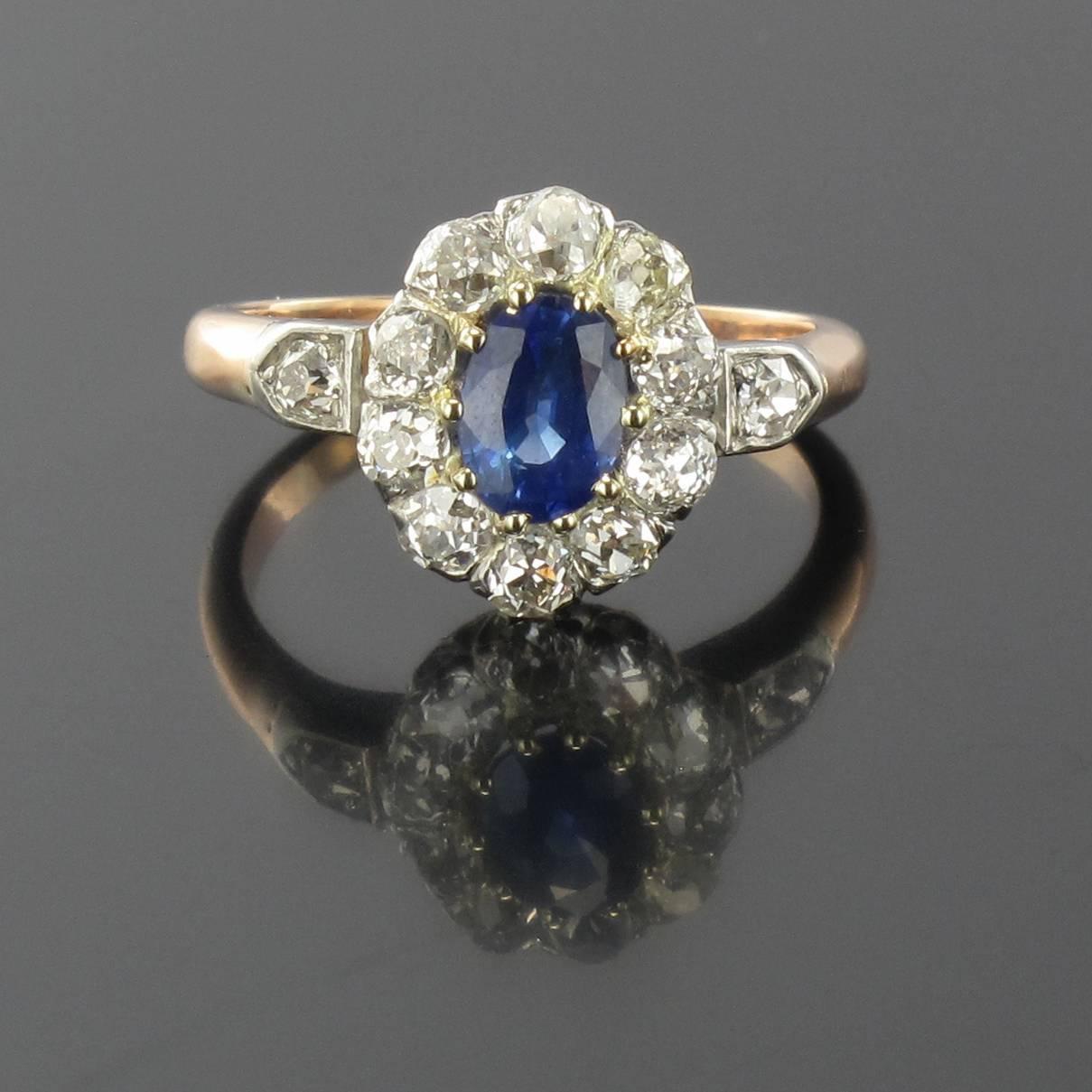 Ring in 18 carat rose gold, eagle head hallmark. 

This splendid antique ring features a claw set oval sapphire with an antique brilliant cut diamond halo. 

Sapphire weight: 1.32 carat approximately
Total diamond weight: about 0.80
