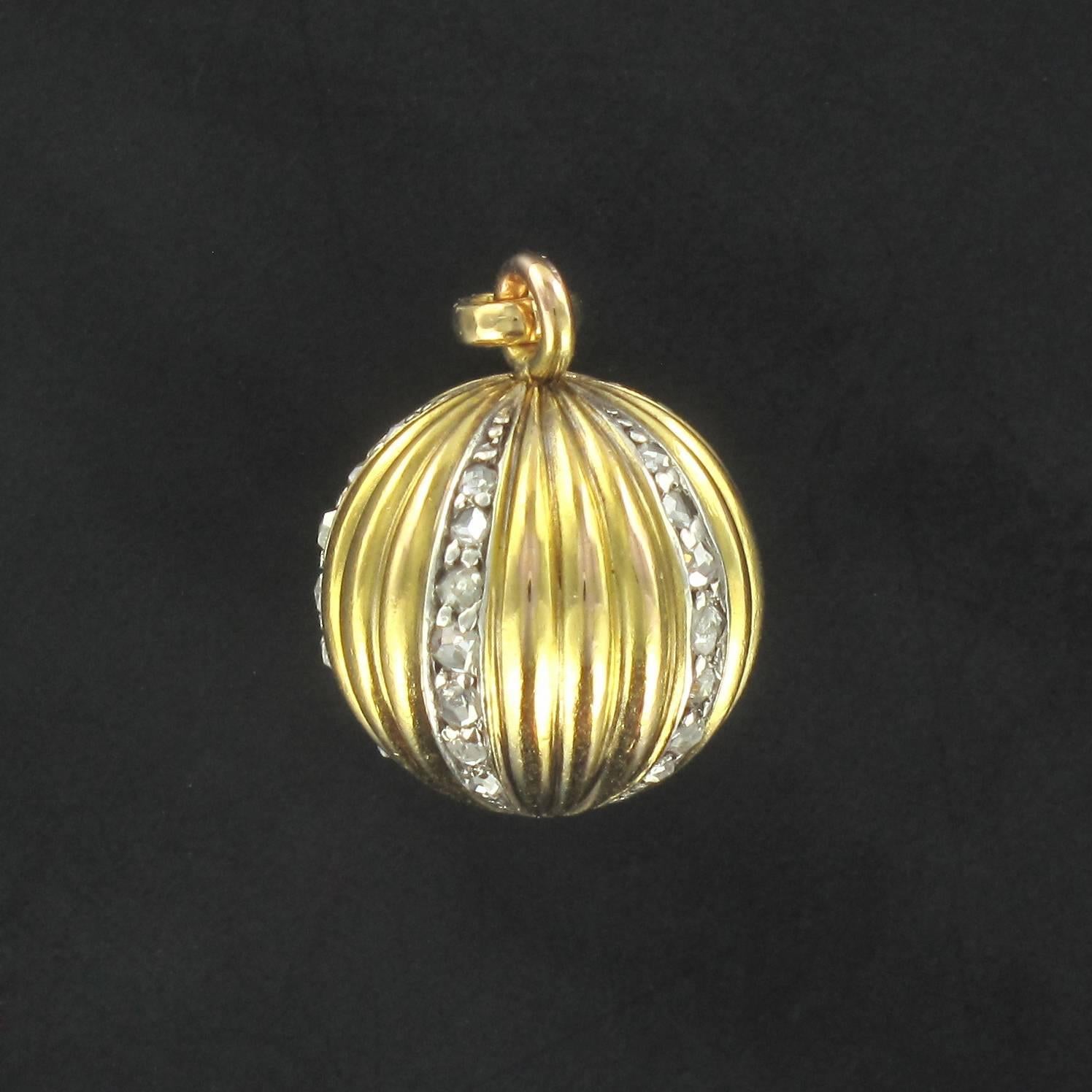 Pendant in 18 carat yellow gold. 

This antique pendant in the form of a ball features golden ridges separated by lines of rose cut diamonds. A larger rose cut diamond is bezel set in the base.  

Authentic antique pendant – French work of the