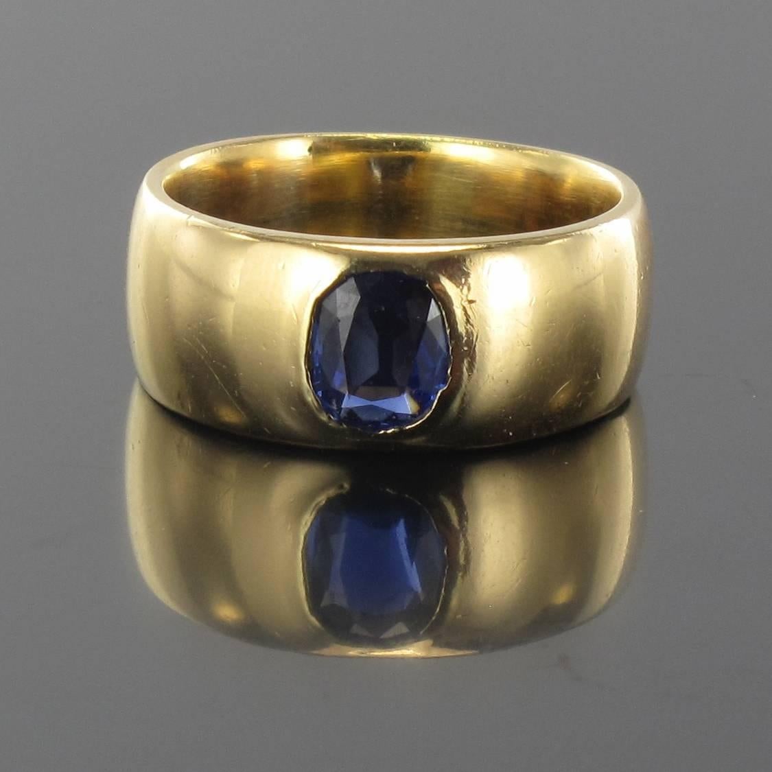 Ring in 18 carat yellow gold. 

This golden band ring is bezel set with an oval sapphire of an intense and deep blue colour. 

Sapphire weight: about 0.50 carat.
Height: 8.02 mm, thickness: 2.8 mm, ring width at the base: 7.2 mm.
Total weight