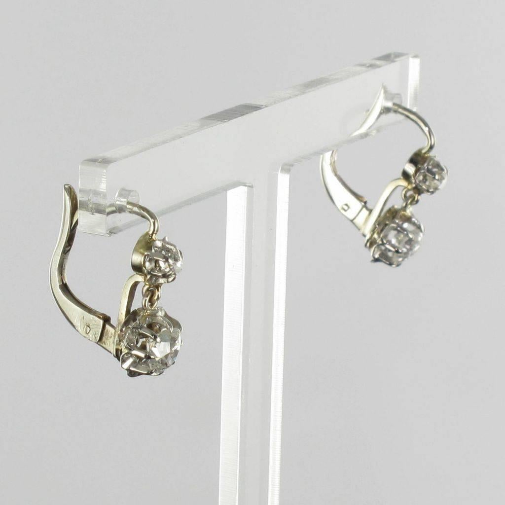 For pierced ears.
Pairs of earrings in 18 carat white gold, eagle head hallmark. 

Each diamond earring features a claw set cushion cut diamond from which is suspended a much larger cushion cut diamond in an illusional setting. The clasp closes