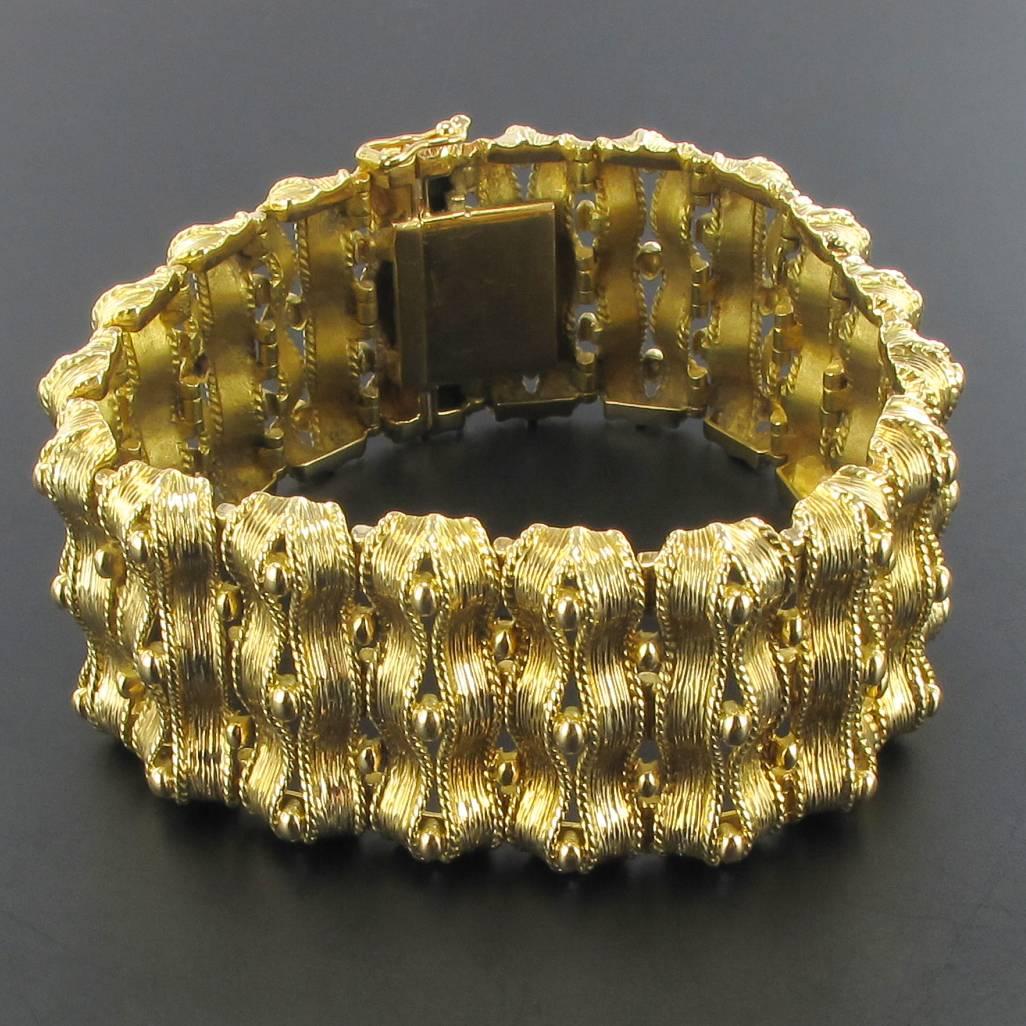 18 carat yellow gold bracelet, rhinoceros head hallmark.
Fully articulated, this splendid bracelet is formed of articulated motifs made of ribbons of chiseled gold spaced with small golden pearls. The clasp is with 8 safety.
Length: 18.5 cm, width