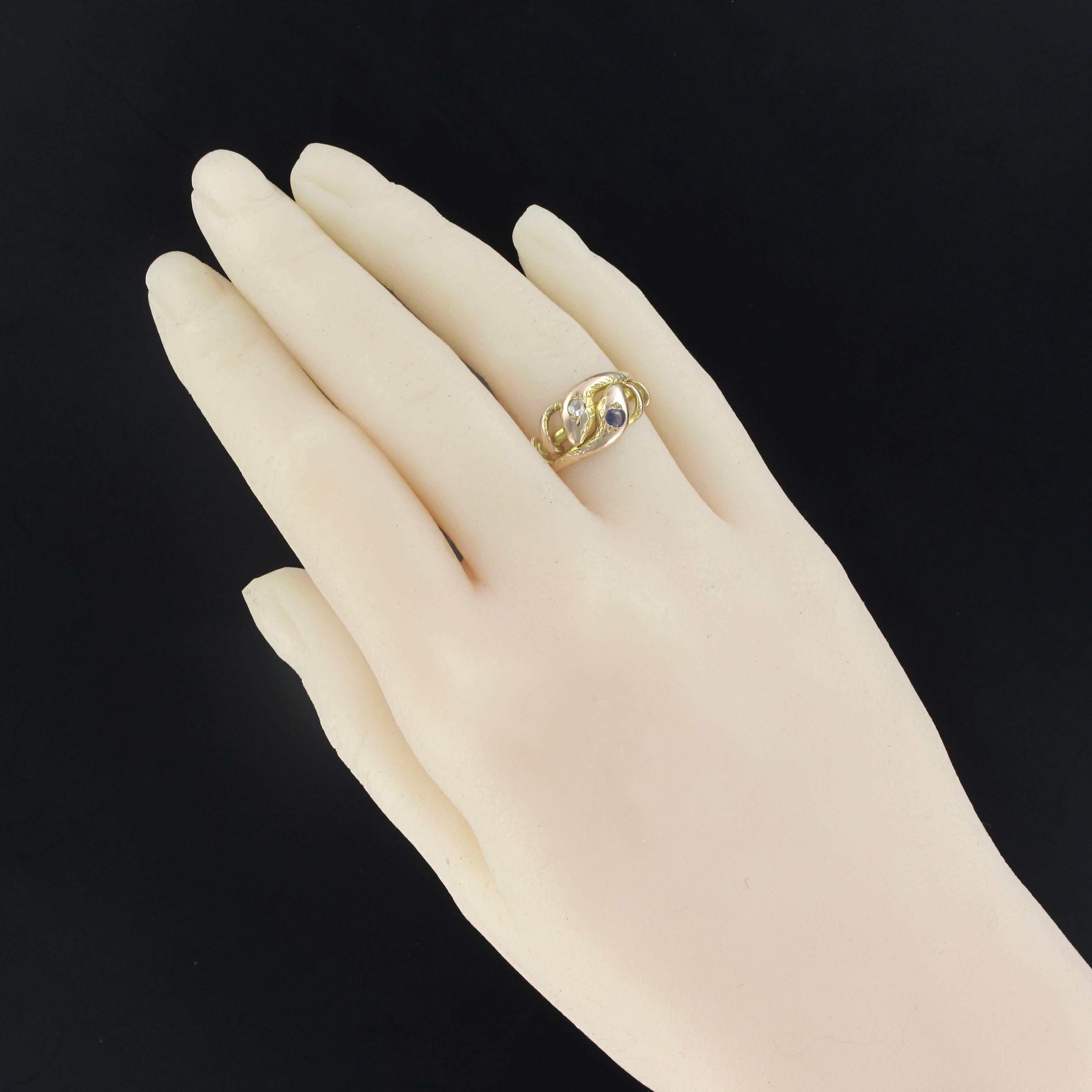 Ring in 18 carats yellow gold.
Highly symbolic, this antique ring is made of 2 snakes that wrap around each other. The two heads are set respectively with an antique brilliant cut diamond and a faceted sapphire.
Height: 9.5 mm; width 19.5 mm,