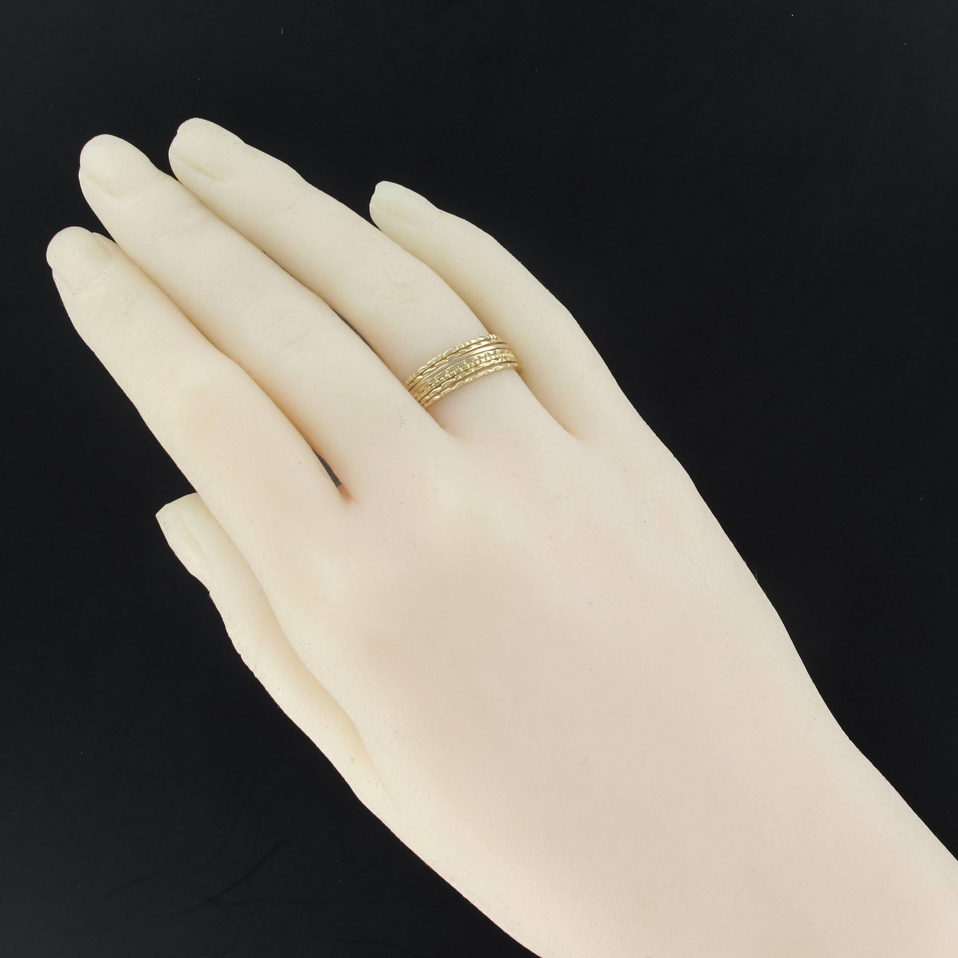 Ring in 18 karats yellow gold.
This ring is made of 7 gold rings each with a different decor and retained between them by a barette of gold.
Height: 7.1 mm, thickness: 1.1 mm.
US Size : 6, for another size please contact us.
Total weight of the