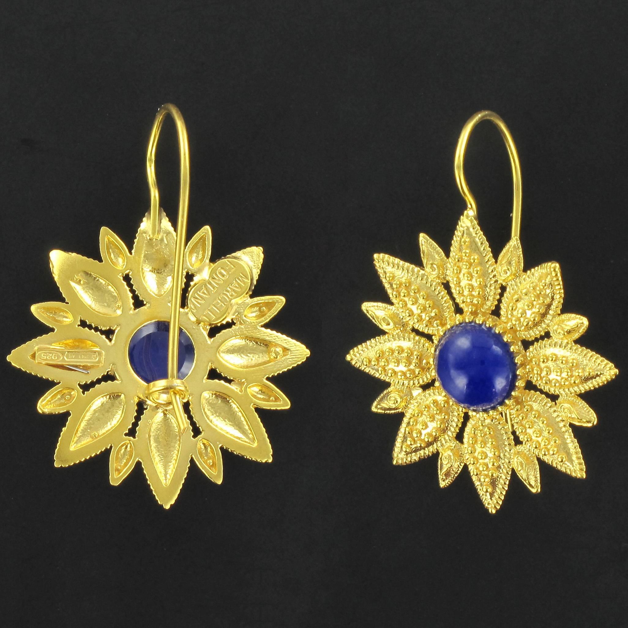 For pierced ears.
Pair of earrings in vermeil, silver and yellow gold.
Drop earrings are set by a cabochon of blue crystal. The clasps are goosenecks with safety hooks. 
Overall length: 3,6 cm, width to the widest: 2,7 cm, thickness to the widest: