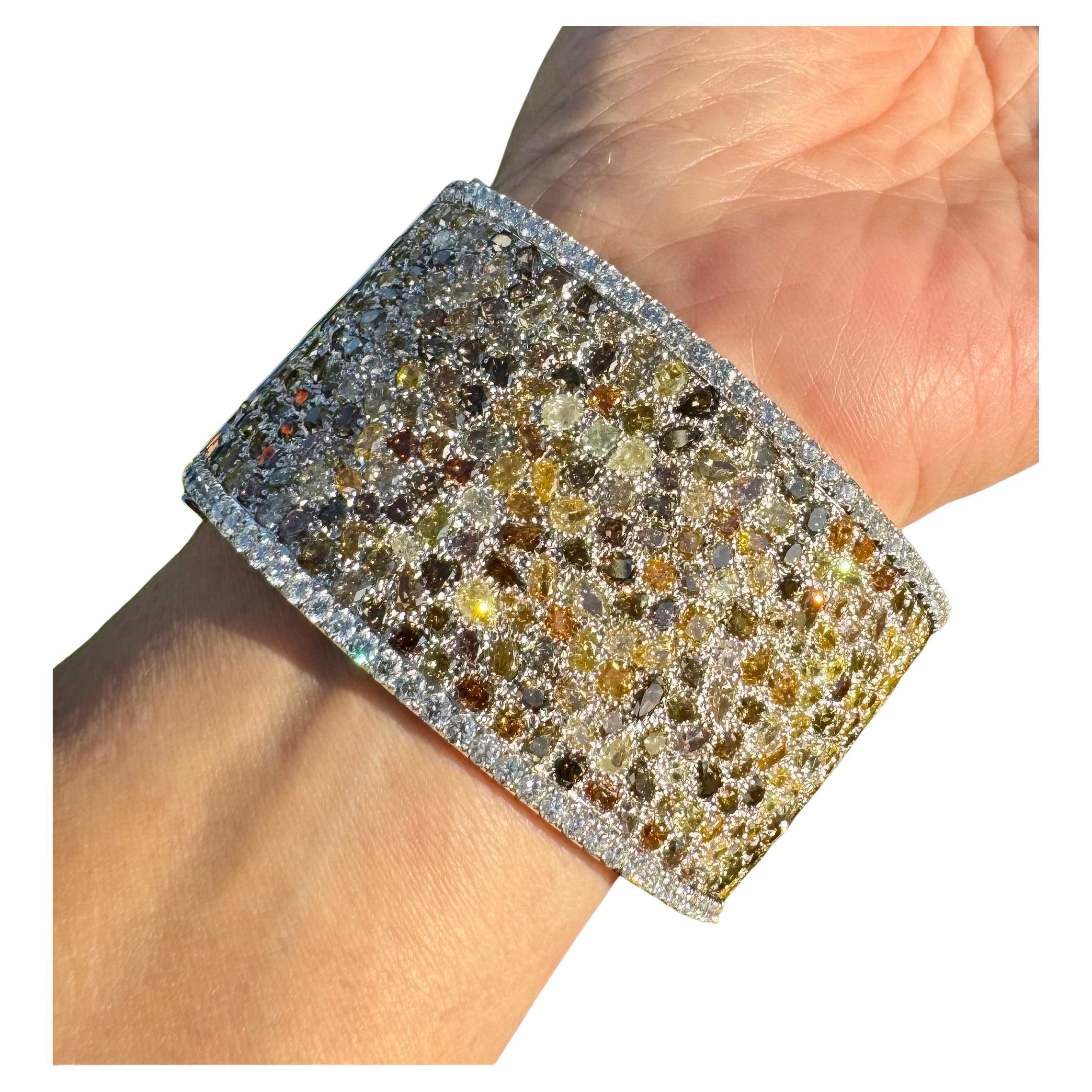 Introducing our multi-colour diamond cuff bracelet, a true masterpiece that combines elegance and luxury. Crafted with meticulous attention to detail, this stunning piece showcases 738 diamonds with a total carat weight of 80.94ct . The central