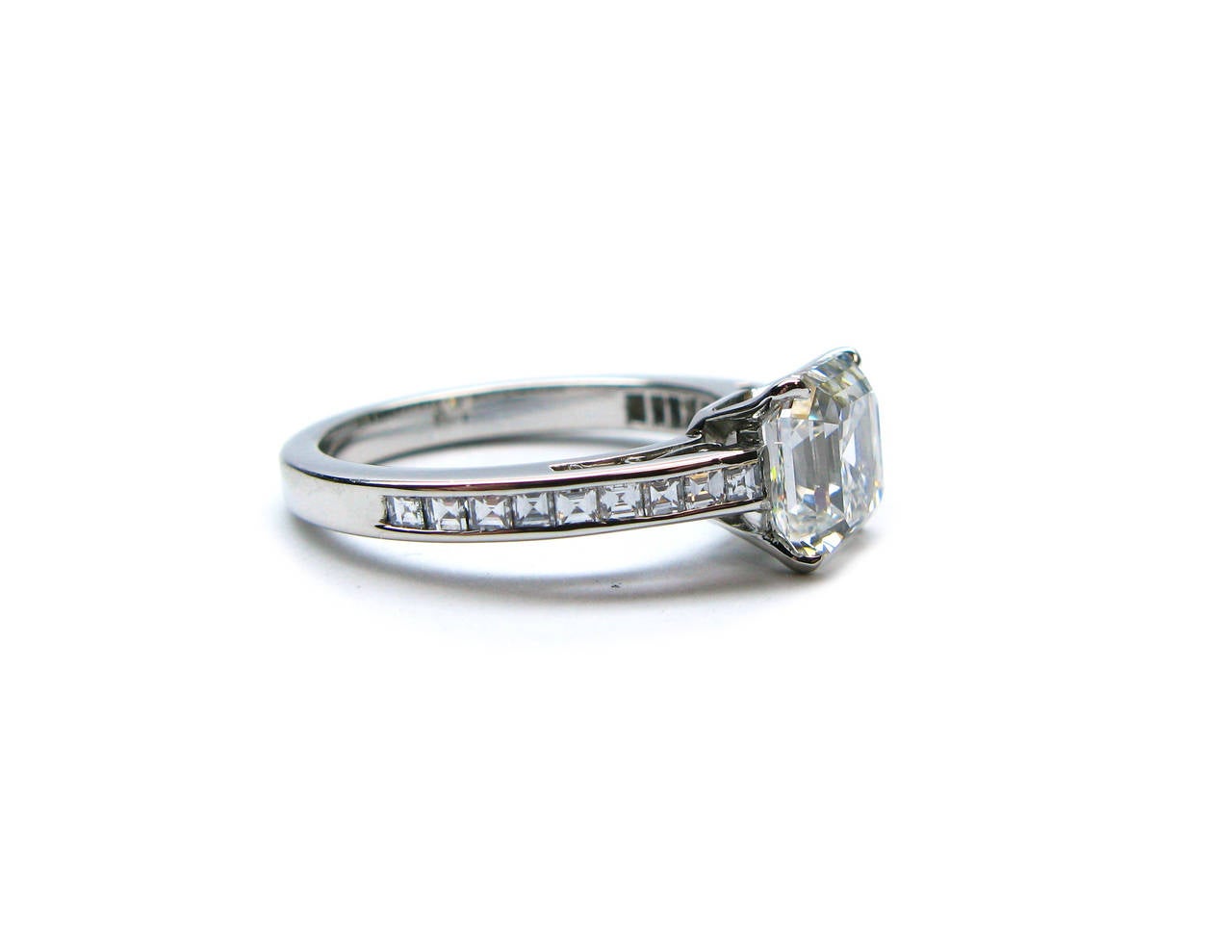 This GIA certified 2.06 ct F color VS2 clarity Asscher cut diamond is set in a beautiful platinum ring with small Asscher cut diamonds set into the band. This ring is sure to dazzle anyone in its tracks.