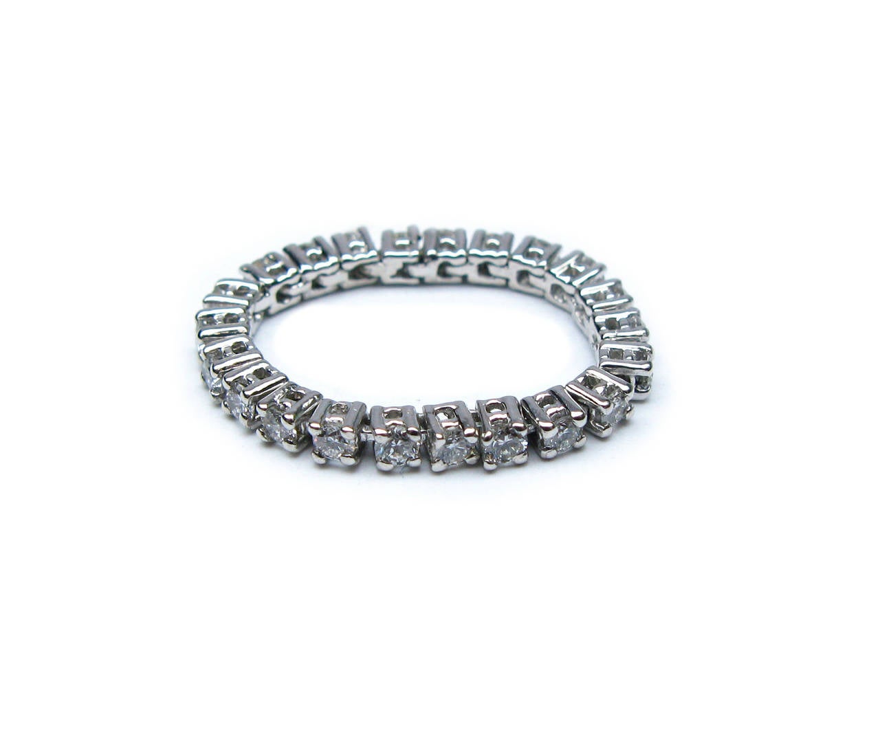 This 18kt white gold band consists of 4-prong flexible baskets containing 0.70ctw round brilliant diamonds. It's the perfect addition to your jewelry box that can be worn everyday and with any outfit. Ring size is 3.0.