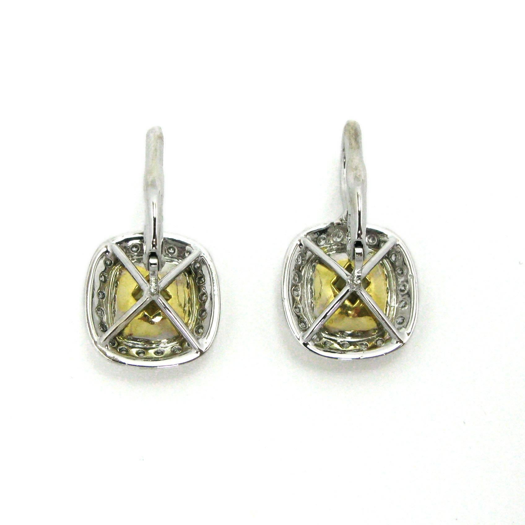 Add a little sunshine to your outfit with these gorgeous yellow and white diamond drop earrings. These earrings feature a 2.01 carat Fancy Light Yellow diamond with SI1 clarity and a 2.08 carat Fancy Yellow diamond with VS2 clarity. 
The two yellow
