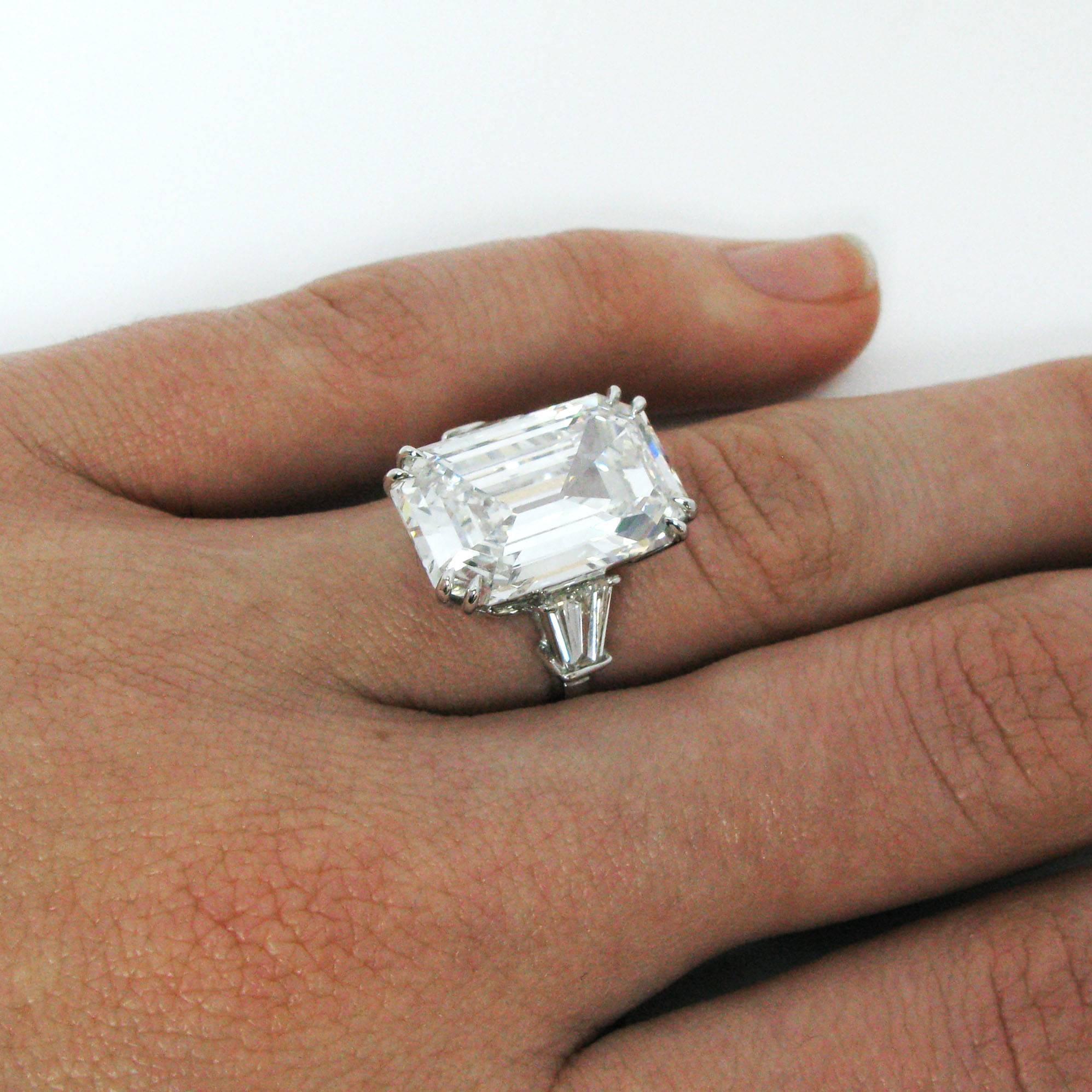 A truly stunning 9.38 carat emerald-cut diamond with F color and VS2 clarity. This stone is set with double claw prongs into a 