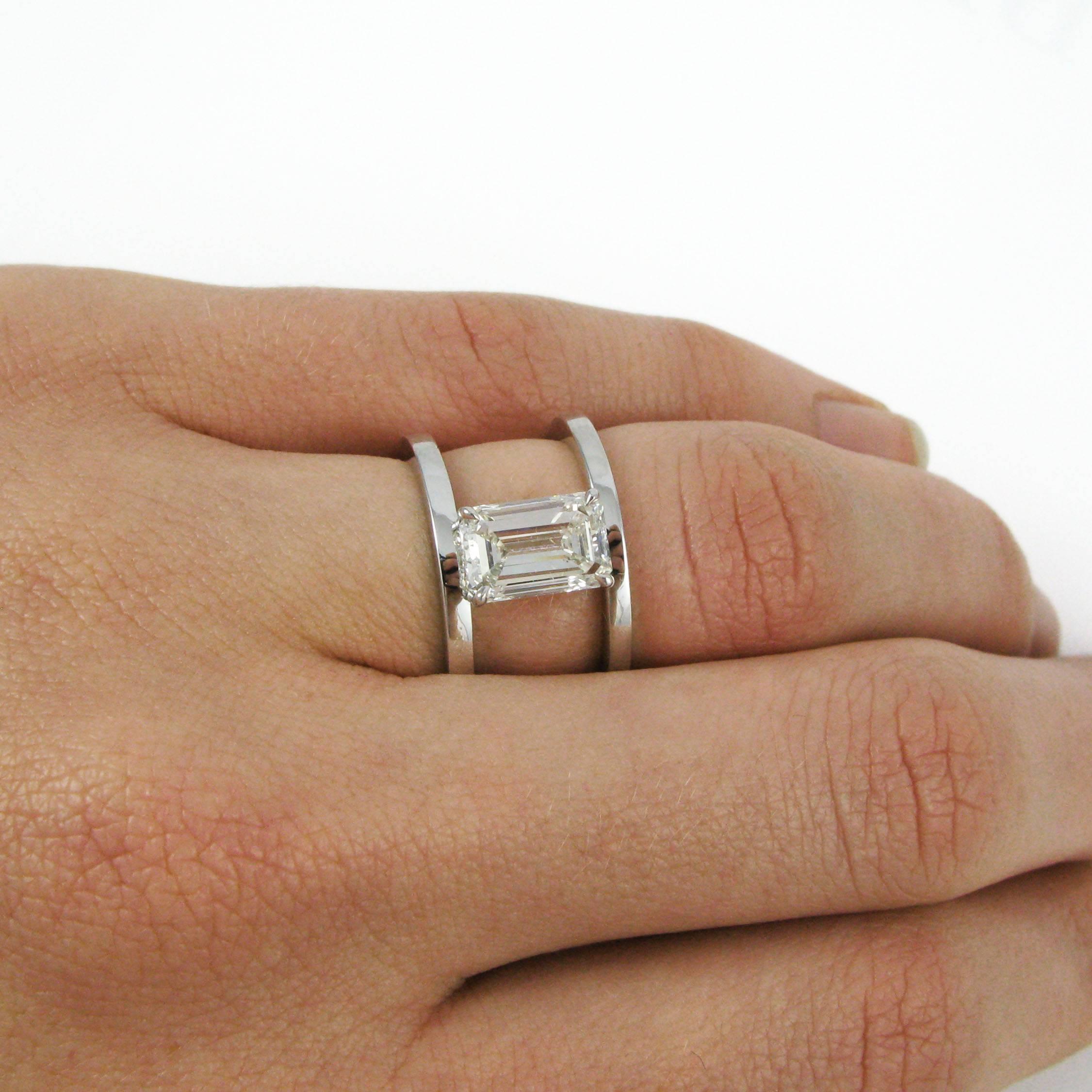A one-of-a-kind style! This unique platinum ring centers on a 2.09 carat emerald-cut diamond prong set and suspended between two parallel bands. A simple design that packs quite a punch!

Purchase includes GIA Diamond Grading Report 15280760,