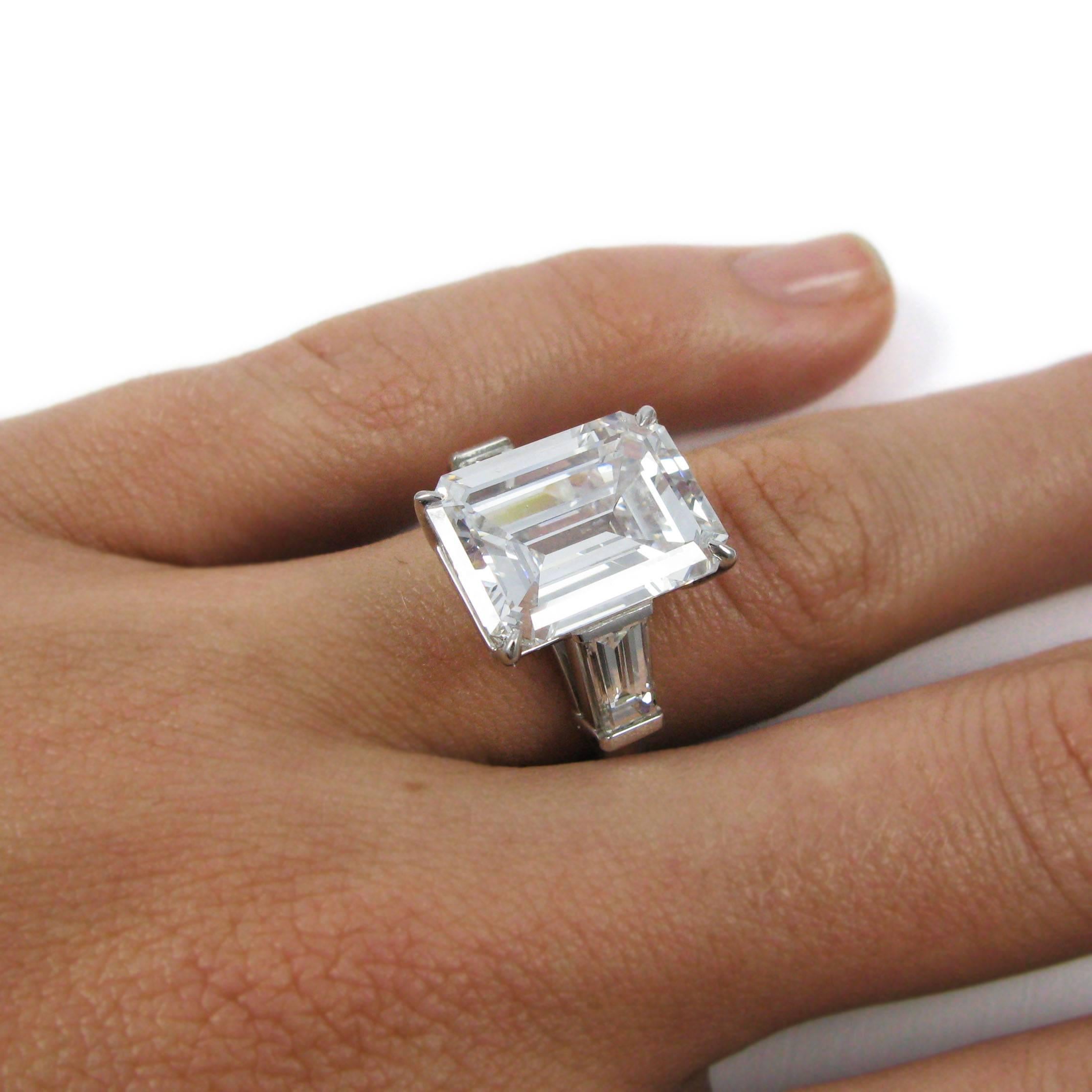 This stunning ring features a 10.01 carat emerald-cut diamond with G color and SI1 clarity. The emerald cut is flanked by two tapered baguette-cut diamonds totaling 1.35 carats in a classic platinum mounting.

Purchase includes GIA Diamond Grading