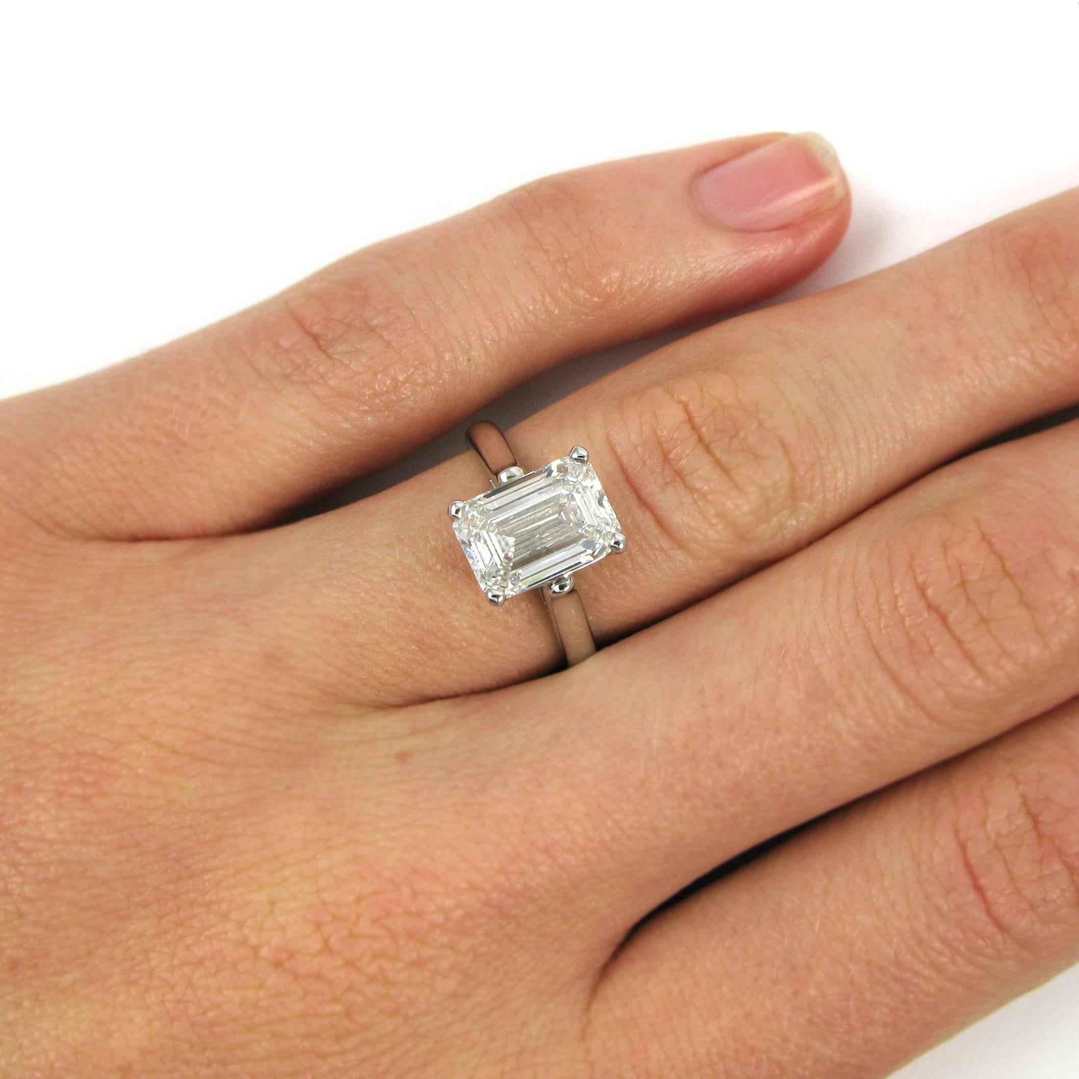 Lovely and classic solitaire ring by American jeweler Tiffany & Co. This ring centers on a 3.09 carat emerald-cut diamond with F color and VS1 clarity. The diamond is mounted simply in platinum, and the ring is stamped "TIFFANY & CO.