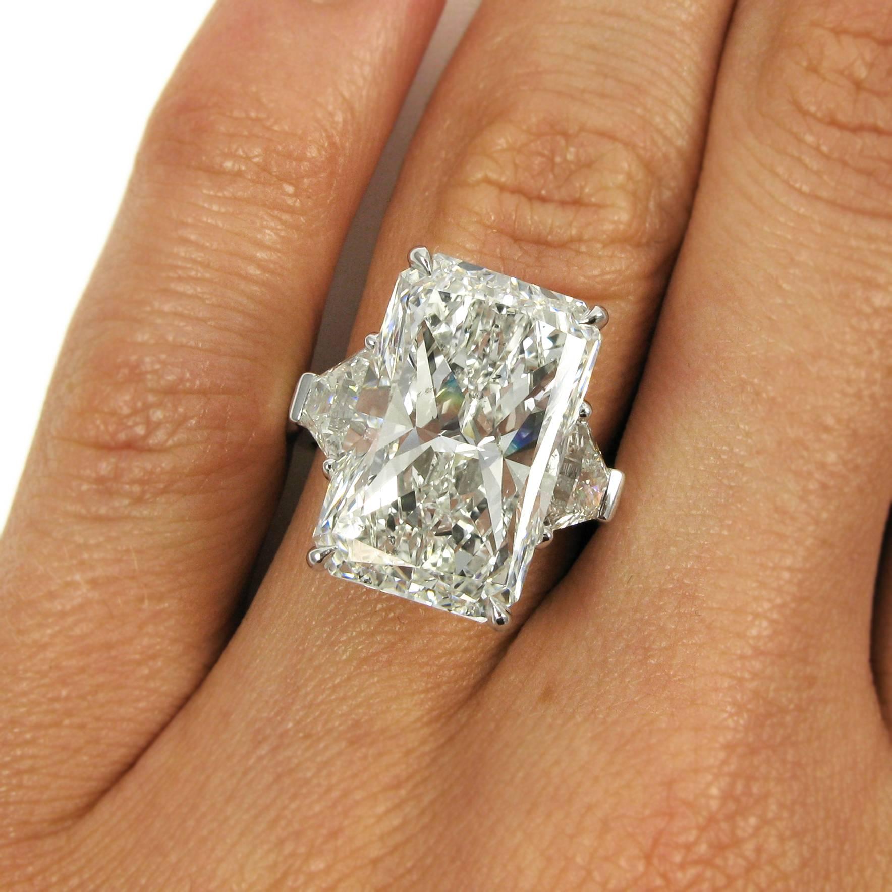 This impressive diamond ring is a unique 12.25 carat elongated radiant-cut diamond flanked by two trapezoid brilliant-cut diamonds in a custom hand-made platinum setting. The center stone has I color and SI2 clarity, while the two trapezoids total