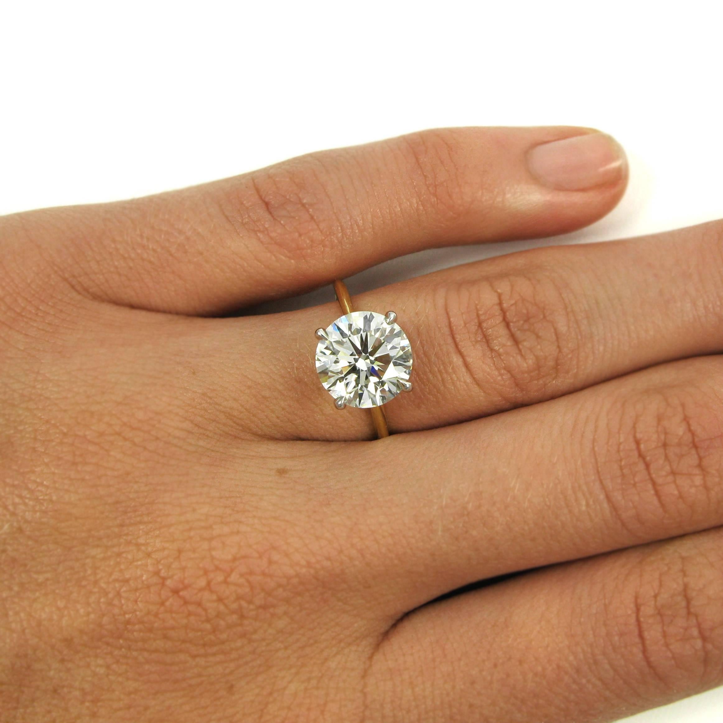 A delicate ring that makes a real statement! A 3.18 carat round brilliant-cut diamond is prong-set into a thin, 18 karat yellow and white gold solitaire mounting. Simple and elegant, with a whole lot of sparkle!

Purchase includes GIA Diamond