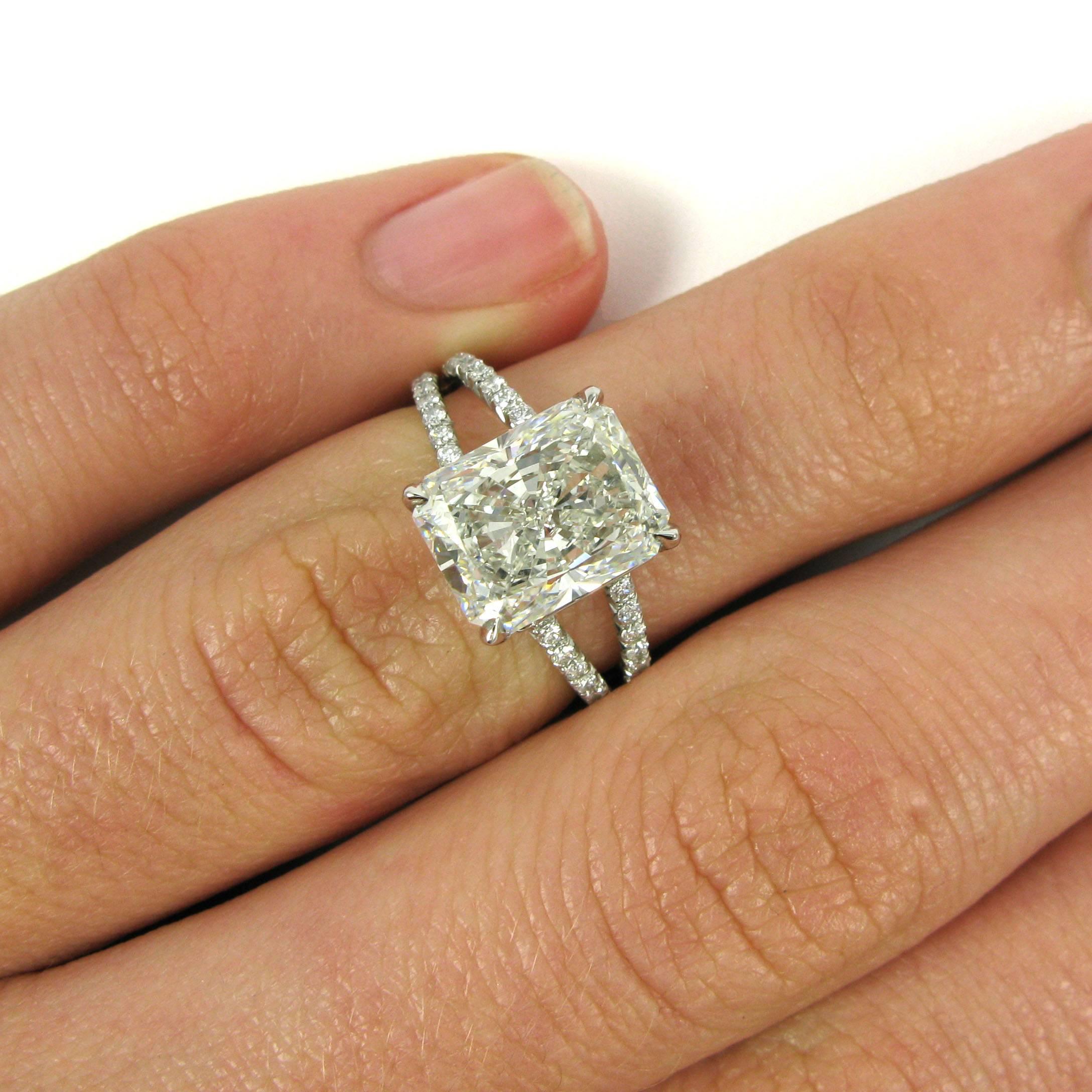 A 3.46 carat radiant cut diamond with H color and VS2 clarity is set in a basket setting atop a delicate platinum split shank ring. Mounting is pave-set with 60 round-cut diamonds totaling approx. 0.90 carats.

Purchase includes GIA Diamond Grading