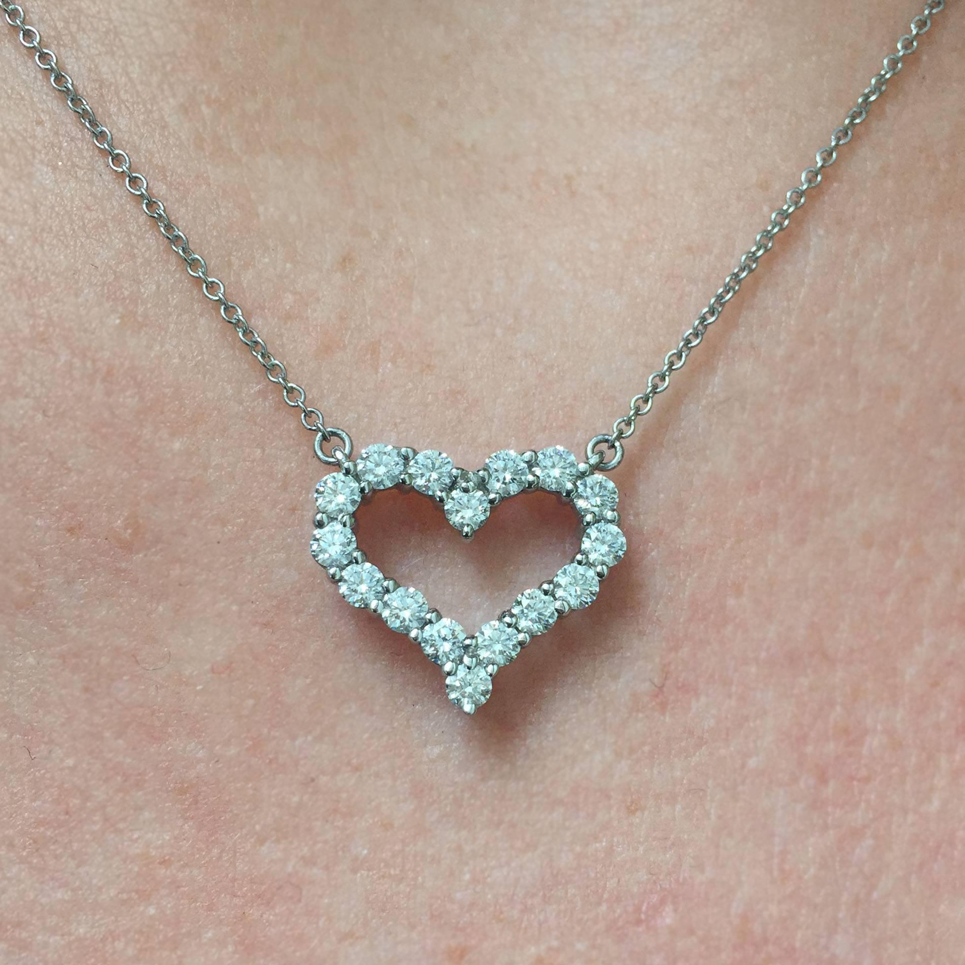 A lovely estate necklace by American jeweler Tiffany & Co. This platinum necklace features 16 round brilliant-cut diamonds prong-set in a heart-shaped pendant fixed on a 16" thin cable chain. The diamonds weigh approx. 0.72 carat total, and