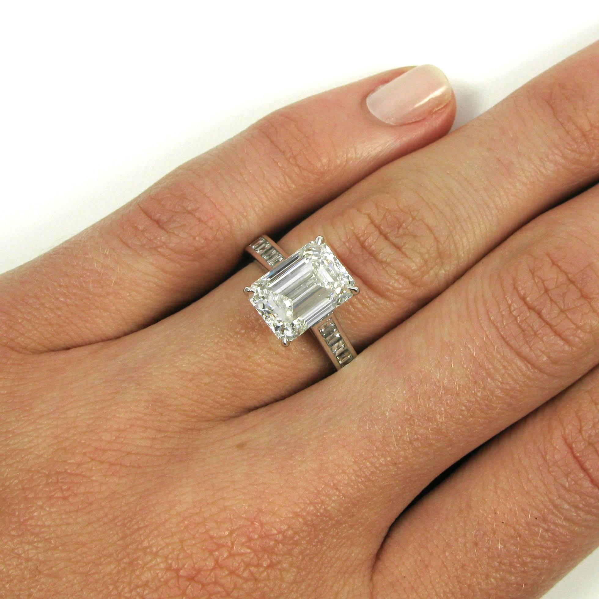 Subtle sparkle! This elegant platinum ring features a 4.01 carat emerald-cut diamond with G color and VS2 clarity set atop a simple cathedral ring by J Birnbach with 20 square cut diamonds totaling 1.08 carat set in the shank.

Purchase includes GIA