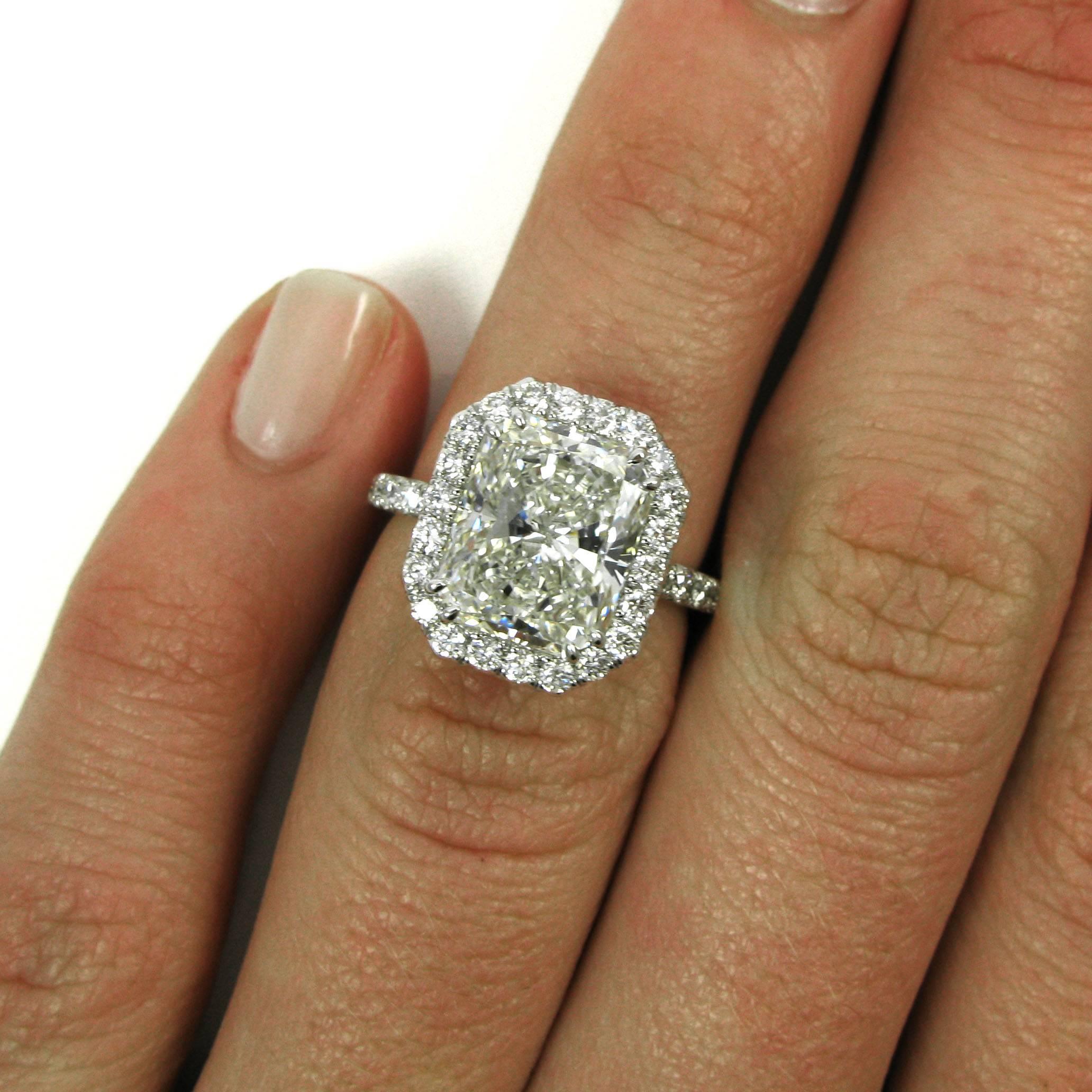 A real showstopper! This 4.04 carat radiant-cut diamond with I color and SI1 clarity is double-prong set into a platinum pave frame mounting studded with approx. 1.00 carat of round pave-set diamonds. 

Purchase includes GIA Diamond Grading Report