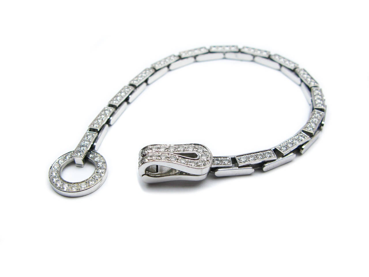 This lovely Cartier signed Agrafe Collection bracelet features high quality white diamonds set in 18kt white gold. 