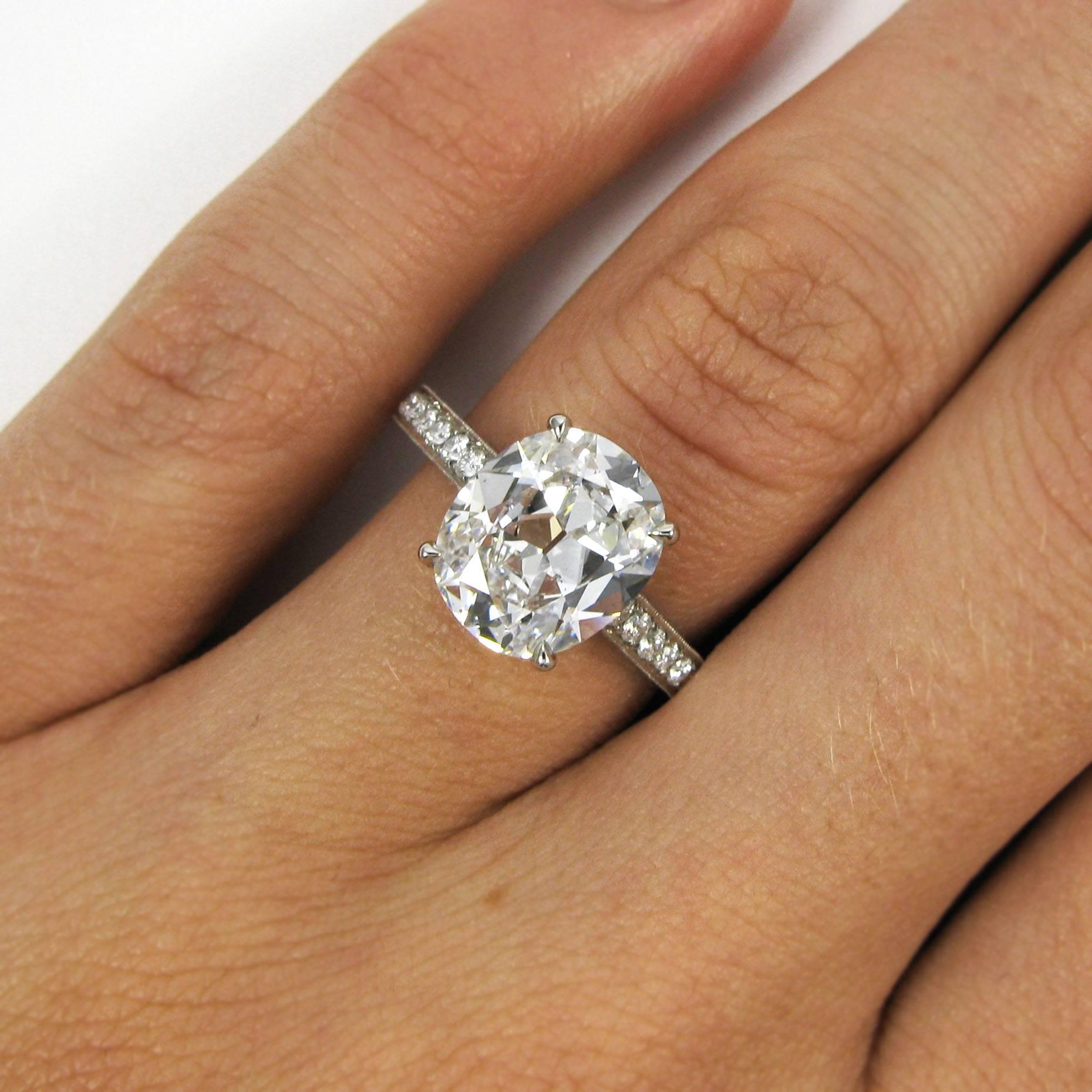 A lovely engagement ring featuring a spready 3.15 carat cushion-cut diamond with D color and SI1 clarity. This unique stone has a vintage appeal, and is set upon a sparkling platinum shank set with 1.09 carats of micro-pave diamonds across all