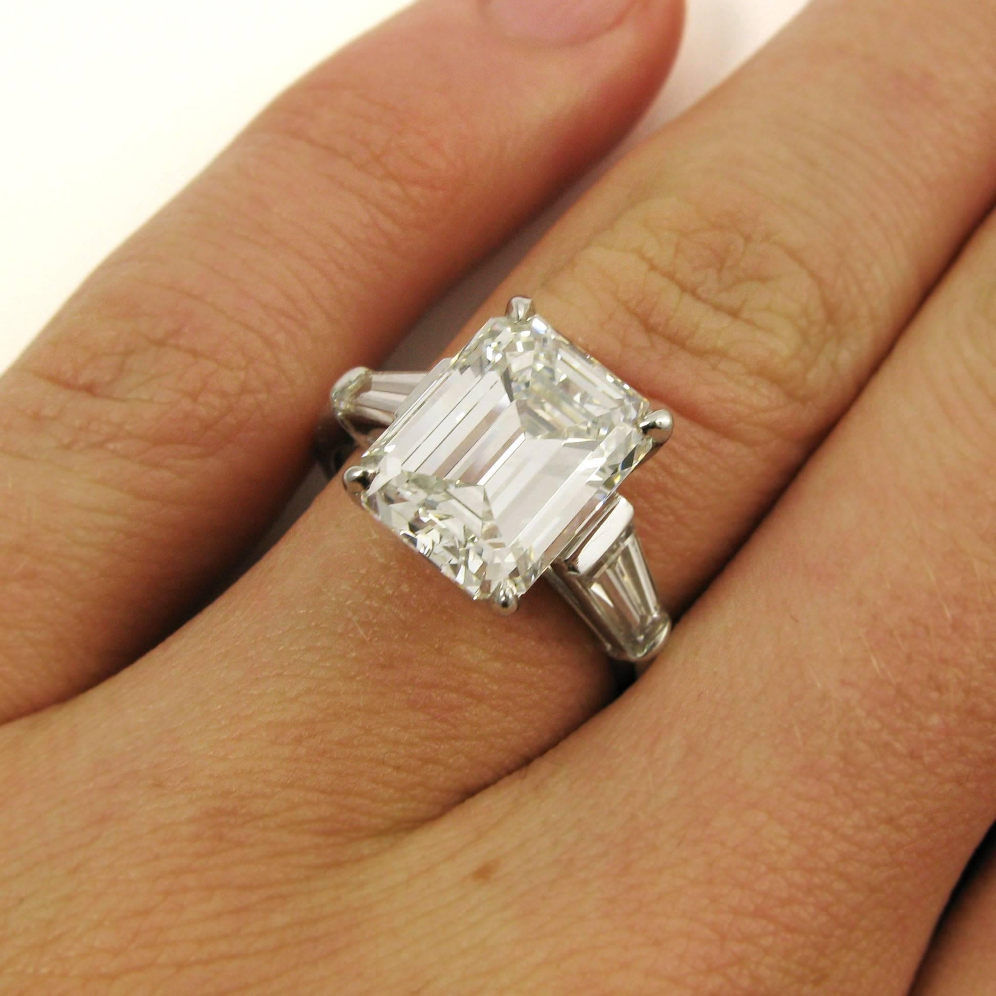 A classic style, this ring features a lovely 4.86 carat emerald-cut diamond with H color and VS1 clarity flanked by two tapered baguette-cut diamonds totaling approx. 0.65 carat. Mounted in platinum.

Purchase includes GIA Diamond Grading Report