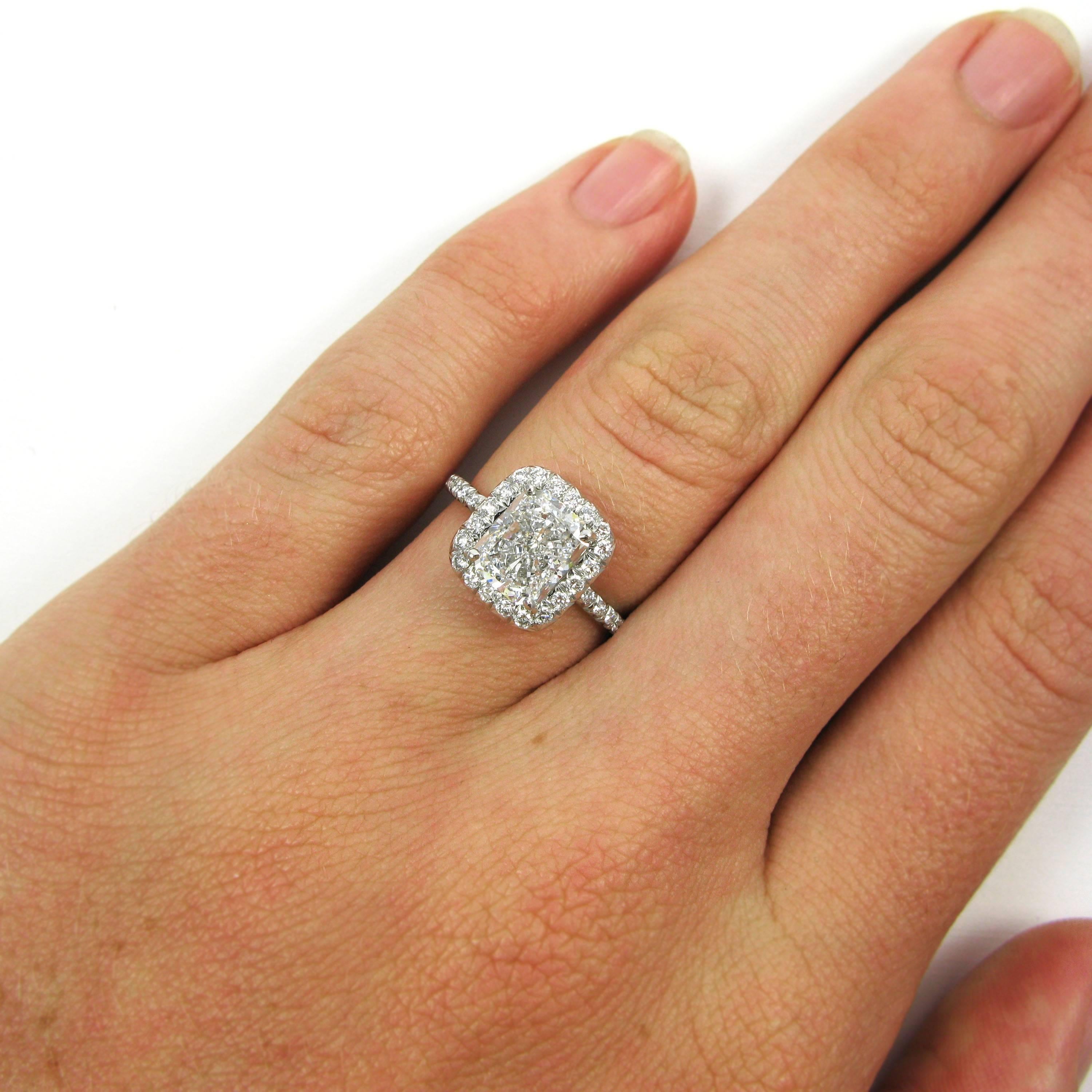 A lovely 1.80 carat radiant-cut diamond with E color and SI1 clarity is set in a platinum frame ring accented by 0.58 carat of pave diamond accents. 

Purchase includes GIA Diamond Grading Report 5166834140, which states that the 1.80 carat