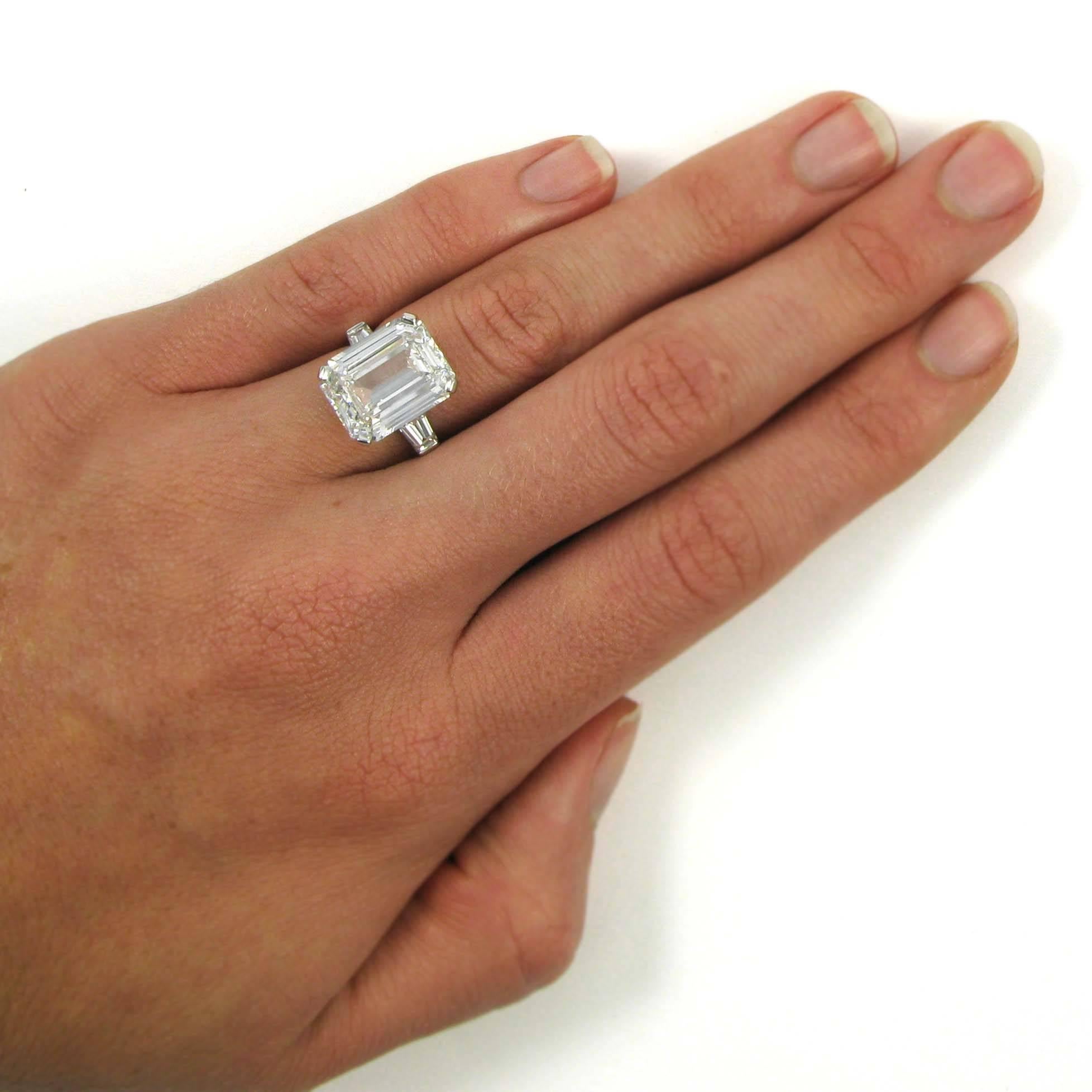 This massive-looking 7.57 carat emerald cut diamond has G color and VS1 clarity, and is flanked by two tapered baguette-cut diamonds for a classic yet impressive look. Mounted in platinum. Side diamonds total approx. 0.50 carat, 

Purchase includes