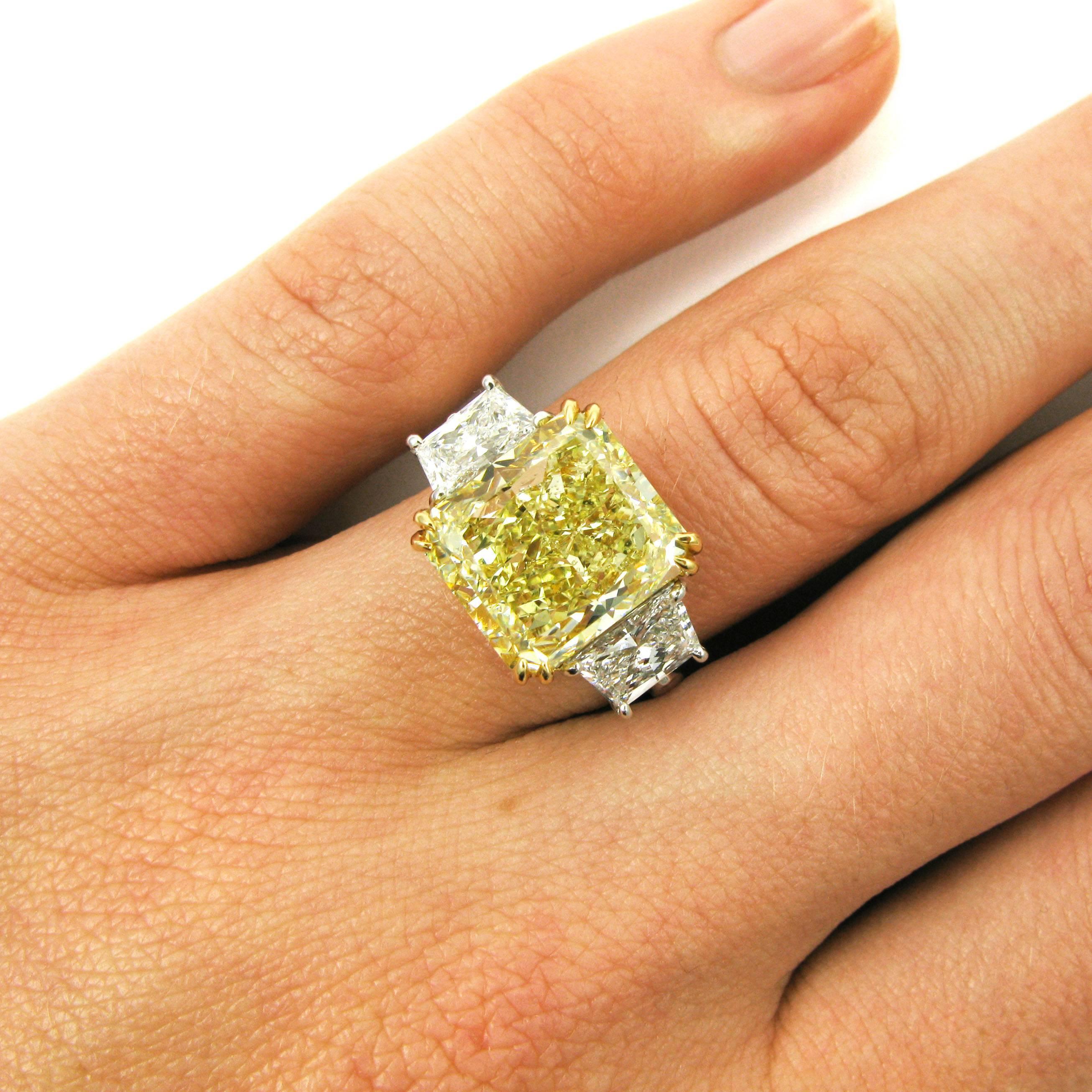 A bright and sunny 7.53 carat radiant-cut diamond with Fancy Yellow color and VS2 clarity. The radiant is set in 18k yellow gold and flanked by two trapezoid-cut white diamonds totaling 1.44 carats. Mounted in platinum. 

Purchase includes GIA