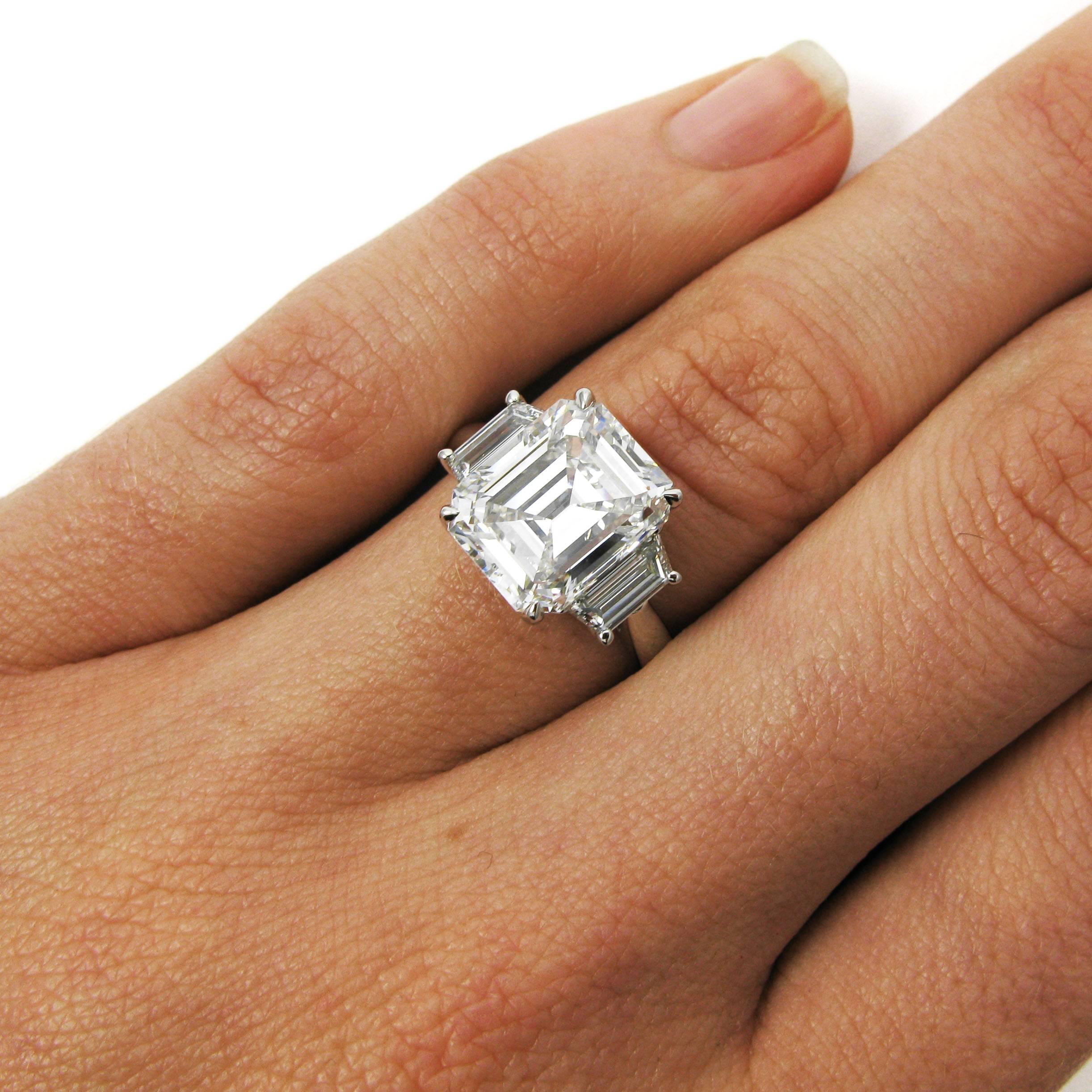 A stunning three stone ring features a 4.14 carat emerald cut diamond with G color and VS1 clarity flanked by two trapezoid-cut diamonds totaling 0.80 carat. Mounted simply in platinum. 

Purchase includes GIA Diamond Grading Report 5181877683,