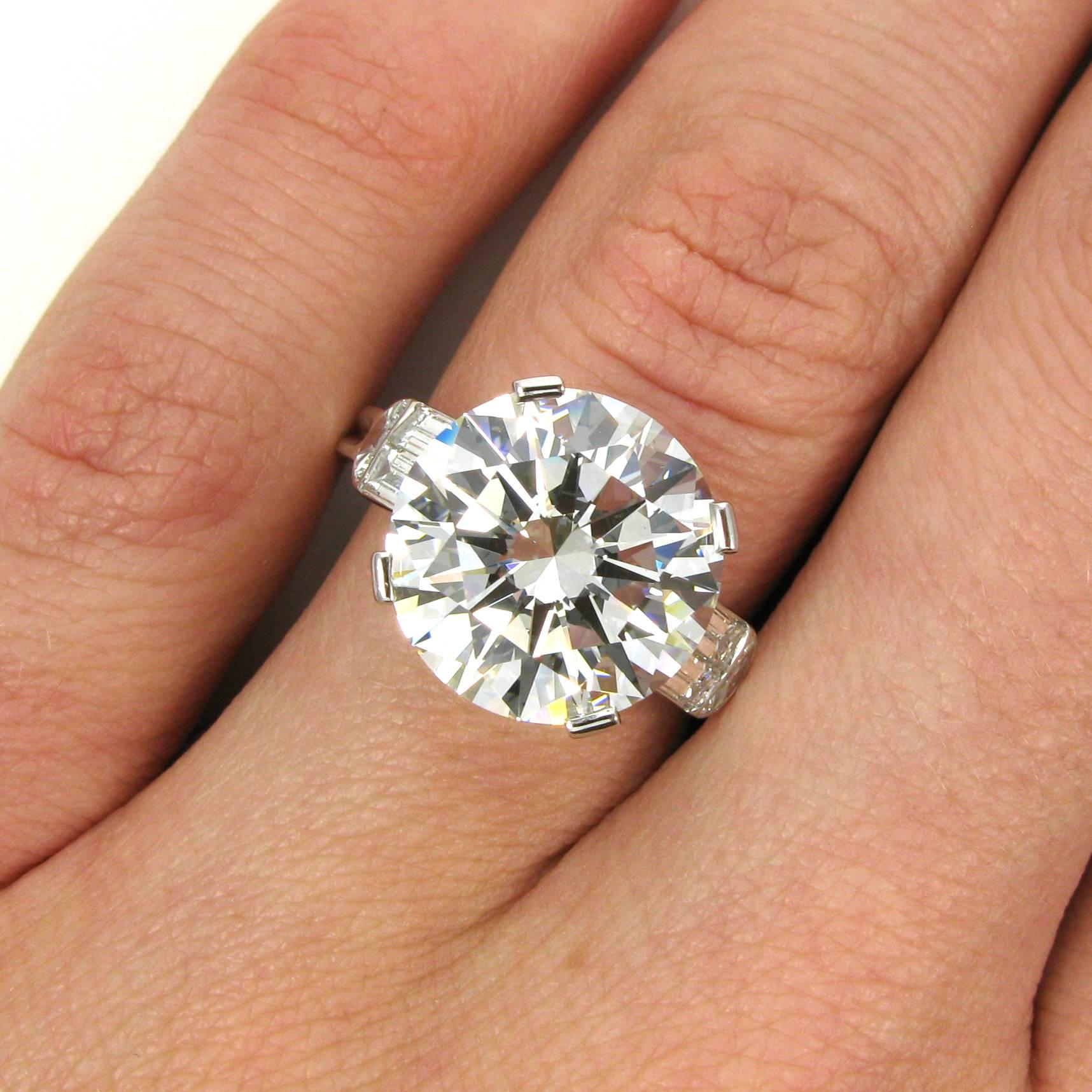 A truly stunning 7.10 carat round brilliant-cut diamond with H color and VS1 clarity. This incredible diamond has excellent cut, polish and symmetry and is set into a J Birnbach platinum mounting accented with four straight baguettes and two