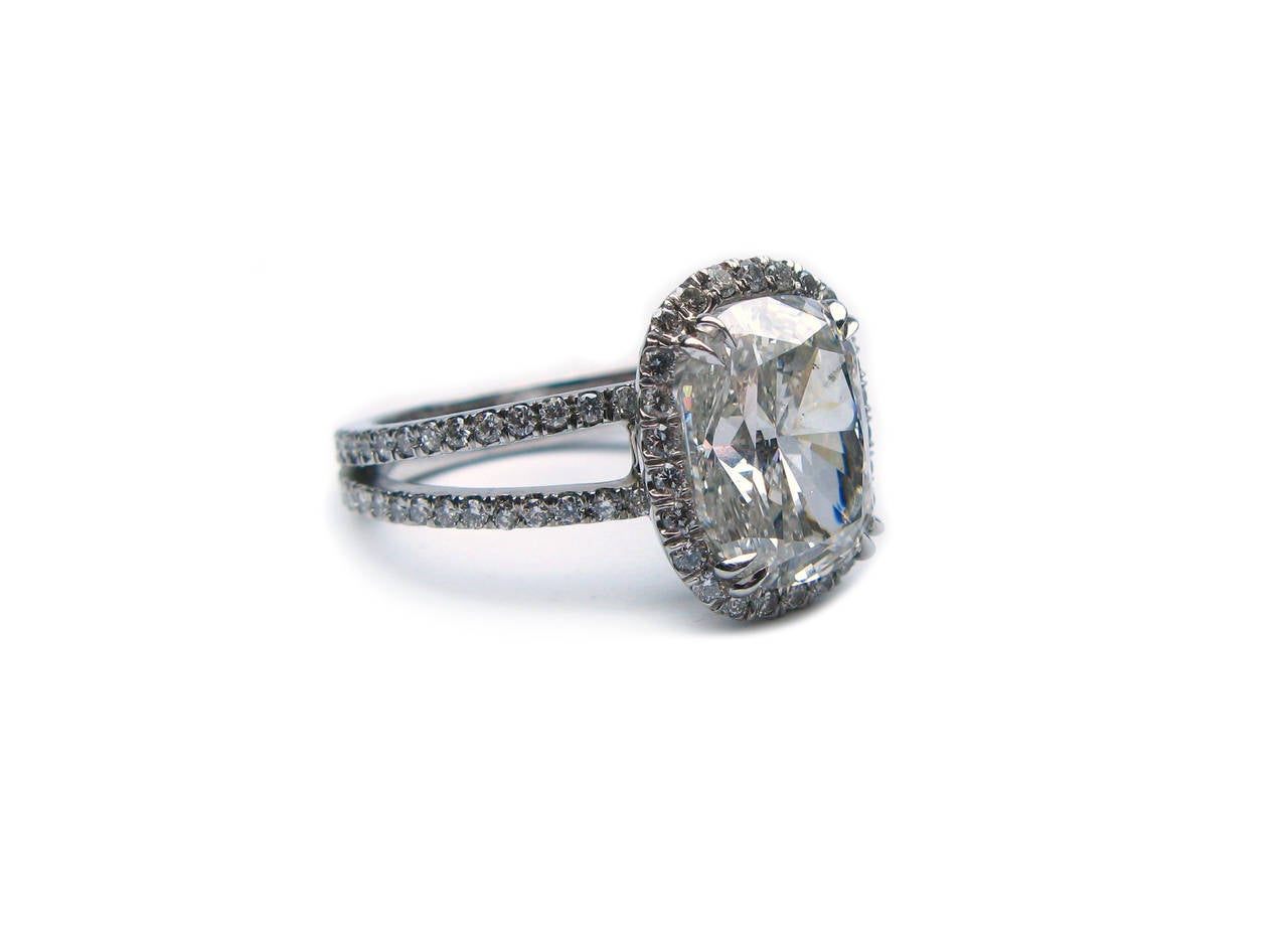 This GIA certified G color SI2 clarity Cushion cut diamond is set in a gorgeous double shank platinum and diamond pave halo ring. This ring is perfect for a bold lady that isn't afraid of a little sparkle!