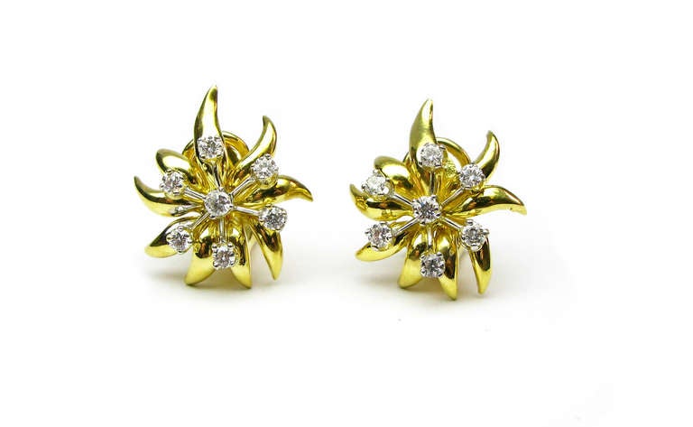 These beautiful Tiffany & Co. signed 18kt yellow gold floral design earrings feature 14 round brilliant diamonds. These lovely earrings are feminine, classic, and a perfect gift for any woman.